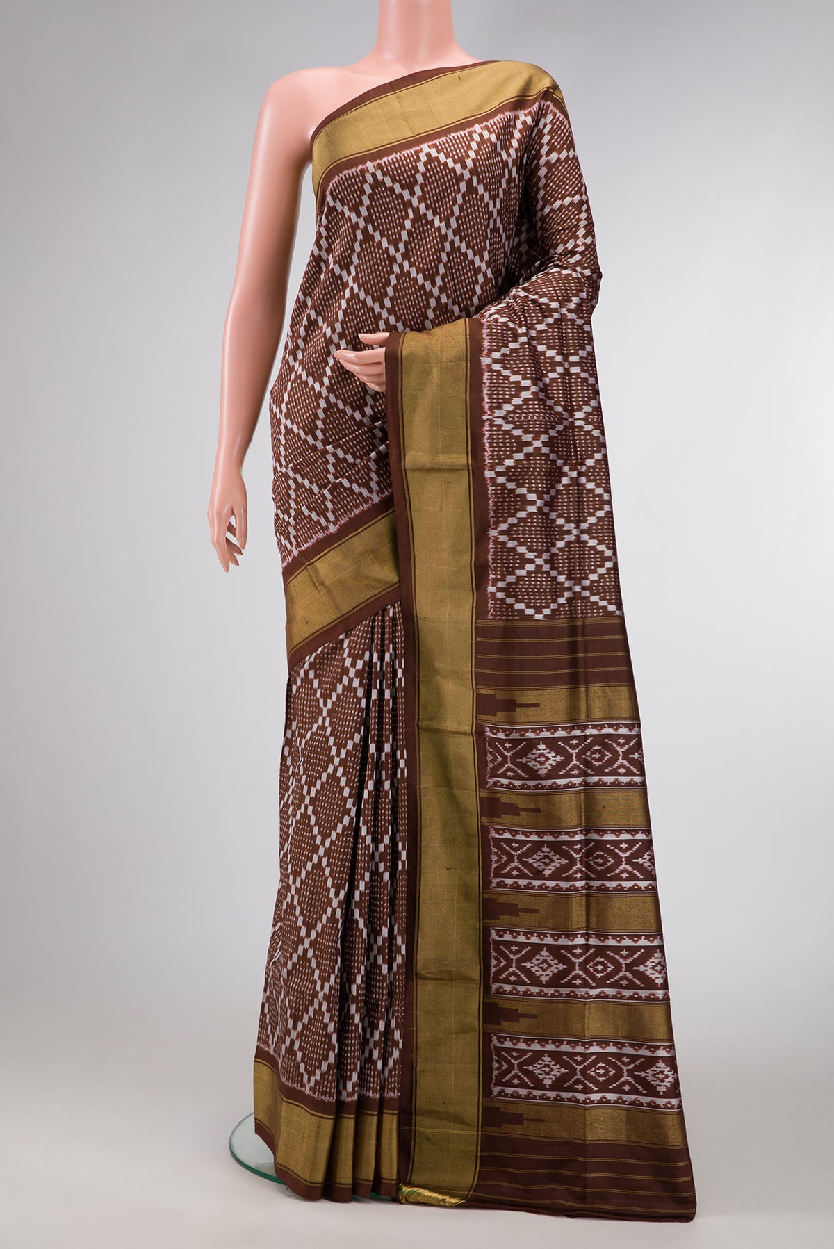 Brown Dual Tone Double Ikat Saree with Ikat Print on the body and Zari Border.  displayed on a mannequin