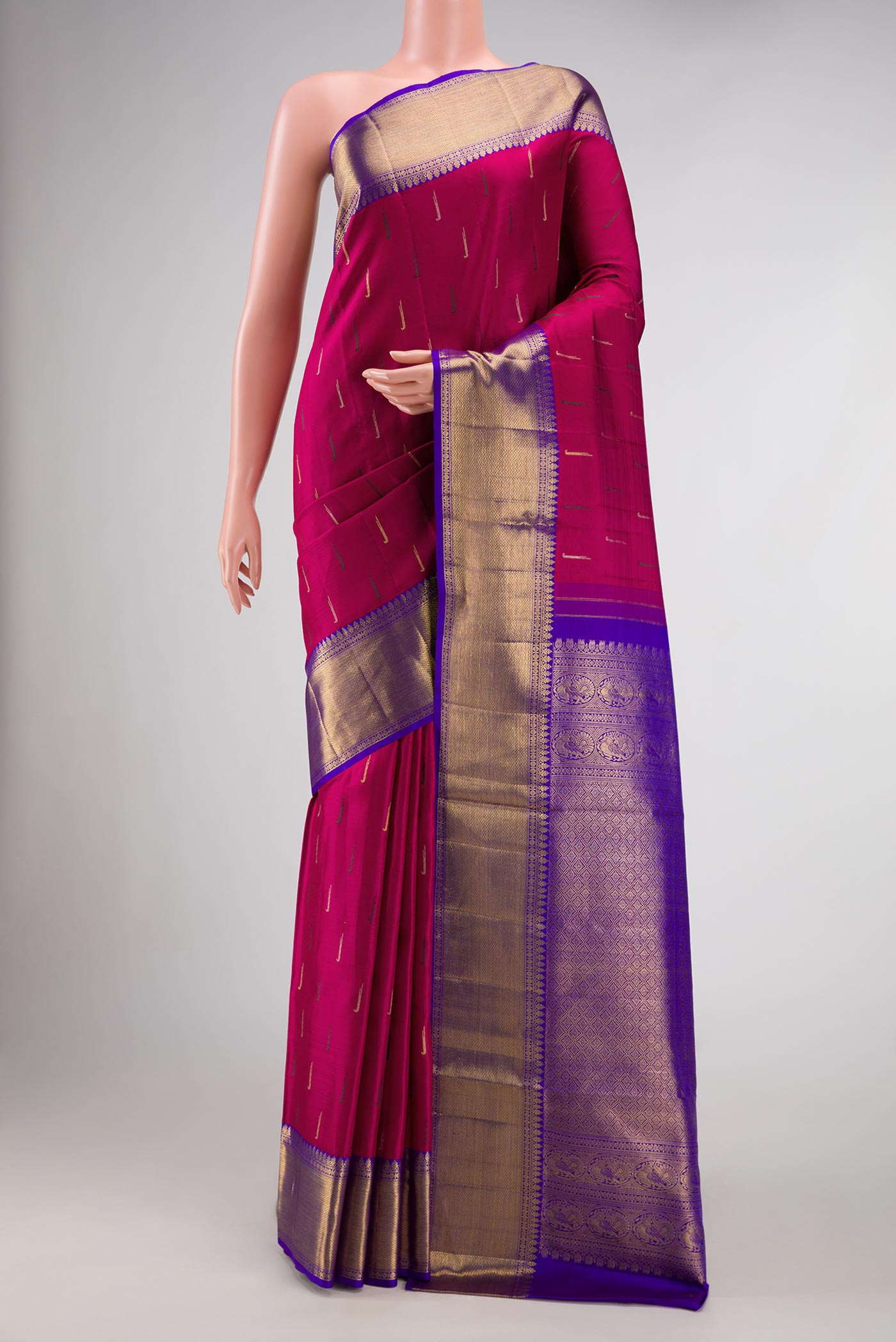 Magenta Dual Tone Kanchipuram Silk Saree with Zari And Thread Butta on the body and Zari Border.  displayed on a mannequin