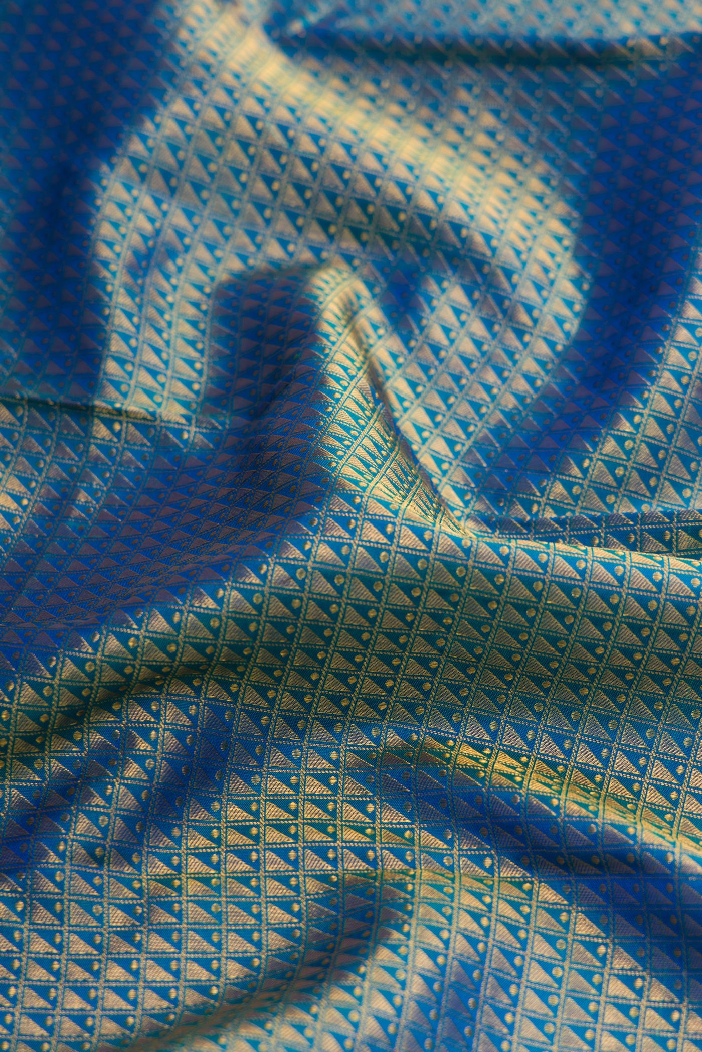 Close up of Peacock Blue Dual Tone Kanchipuram Silk Saree with Zari Brocade on the body and Zari Border.  displaying folds