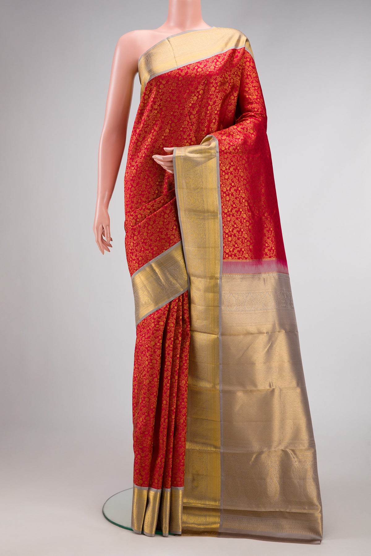 Red Dual Tone Kanjivaram Silk Saree with Zari Brocade on the body and Zari Border.  displayed on a mannequin