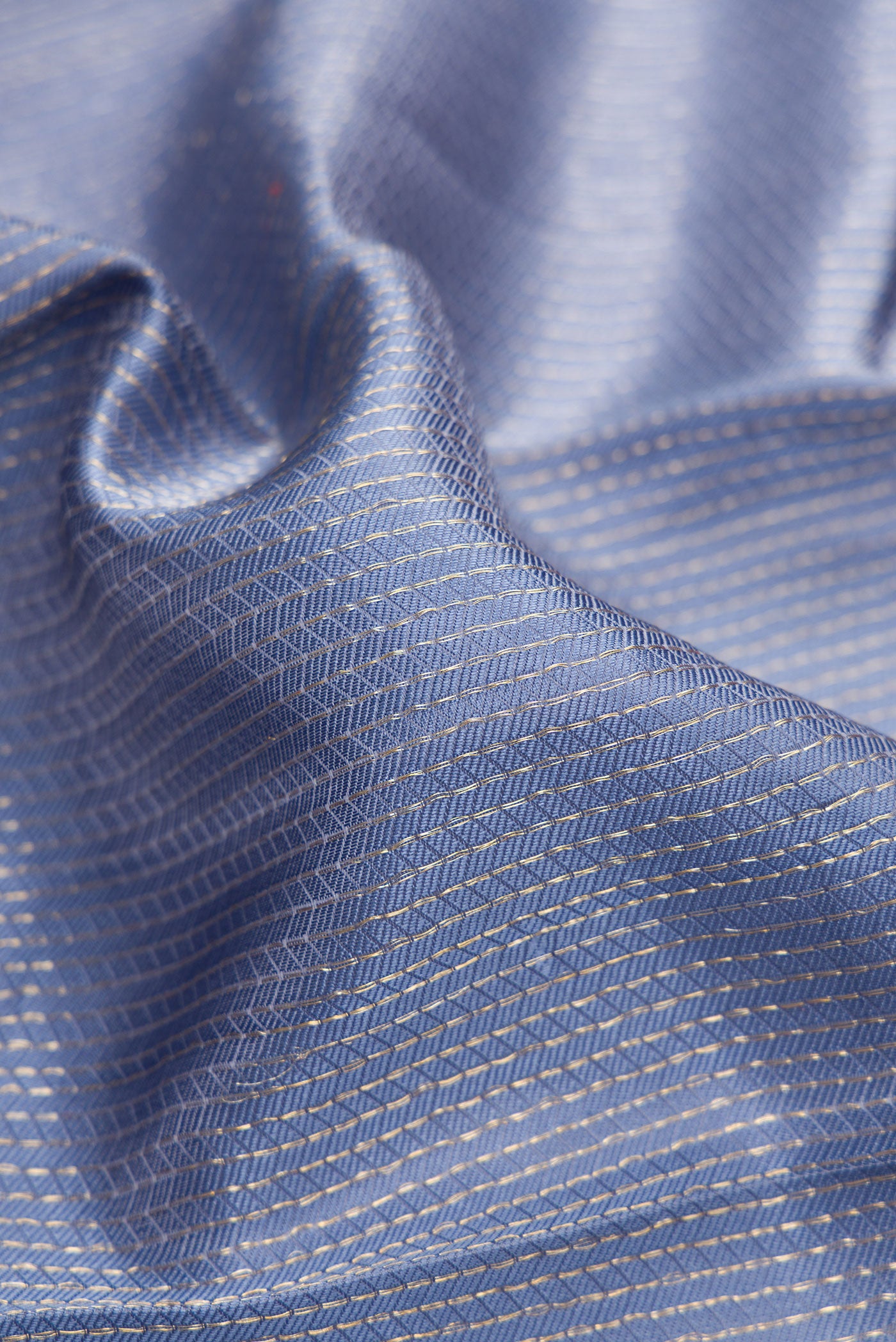 Close up of Blue Grey Kanjivaram Silk Saree with Jacquard design on the body and Zari Border.  displaying folds