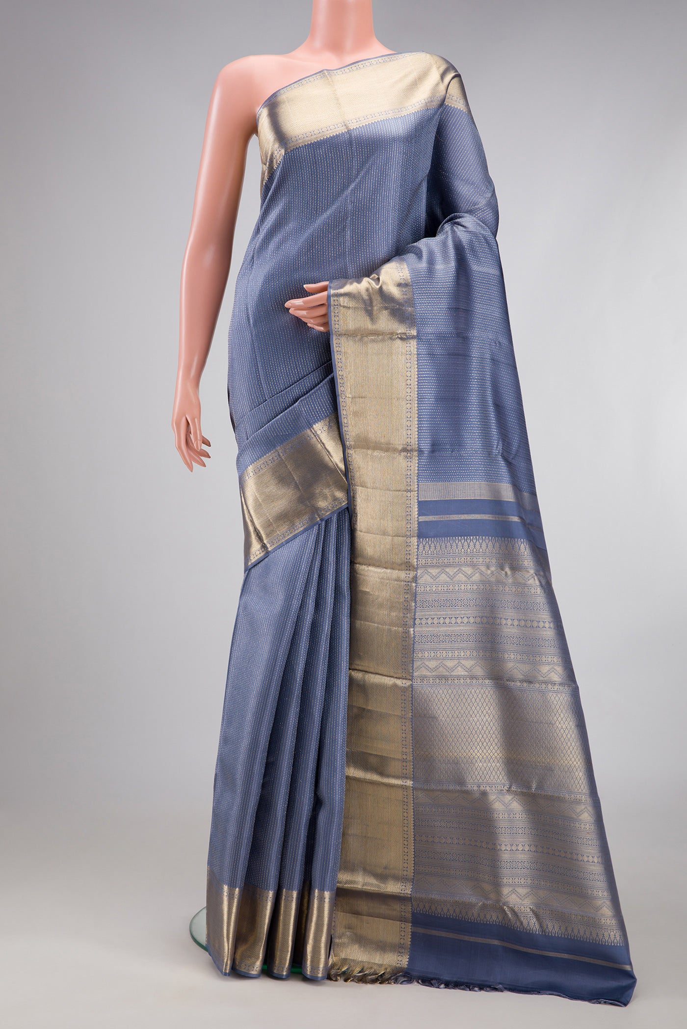 Blue Grey Kanjivaram Silk Saree with Jacquard design on the body and Zari Border.  displayed on a mannequin