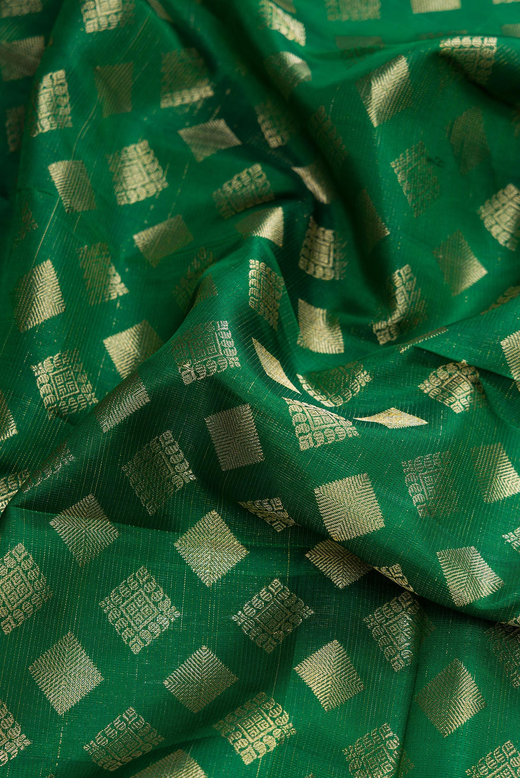 Close up of Green Dual Tone Kanchipuram Silk Saree with Zari Brocade on the body and Zari Border.  displaying folds