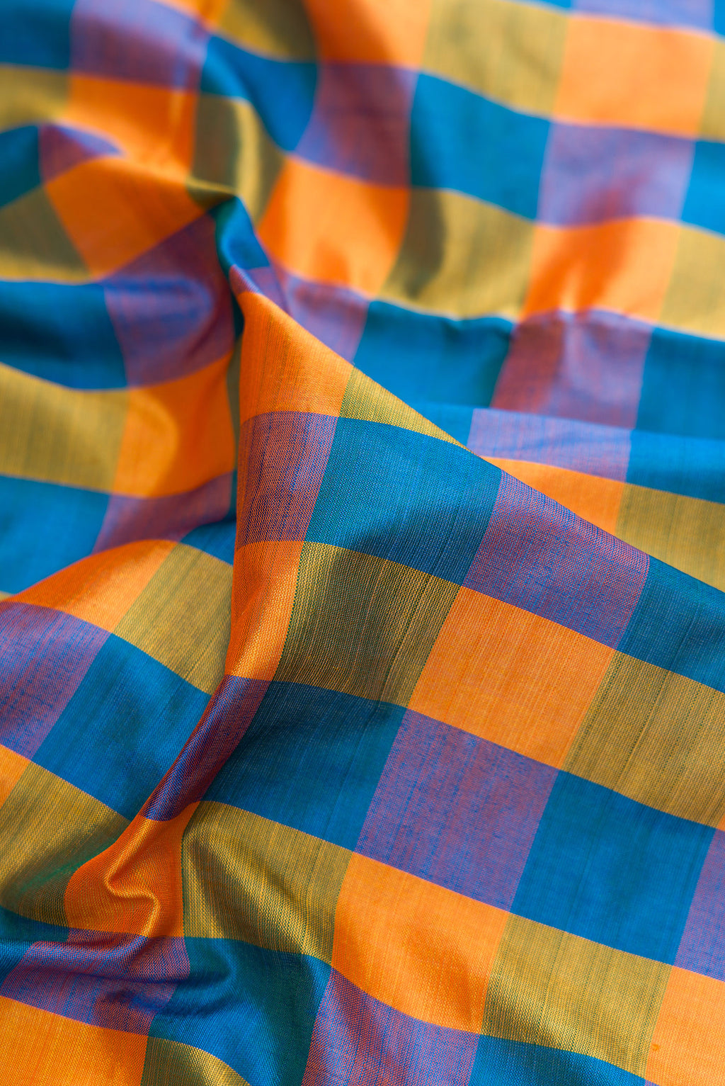Close up of Pure Silk Multi Color Kanjivaram Nine Yards Saree with Checked design on the body and Zari Border.  displaying folds