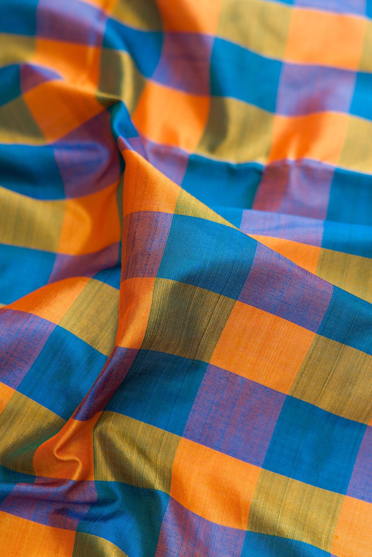 Close up of Pure Silk Multi Color Kanjivaram Nine Yards Saree with Checked design on the body and Zari Border.  displaying folds