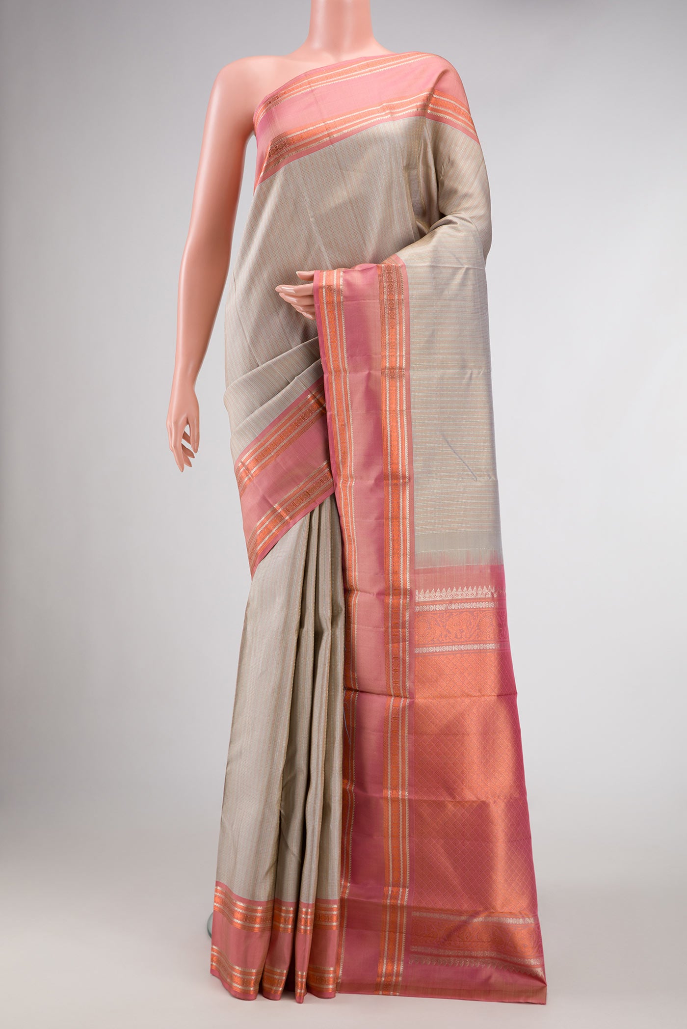 Beige Dual Tone Kanchipuram Silk Saree with Stripes on the body and Zari Border.  displayed on a mannequin