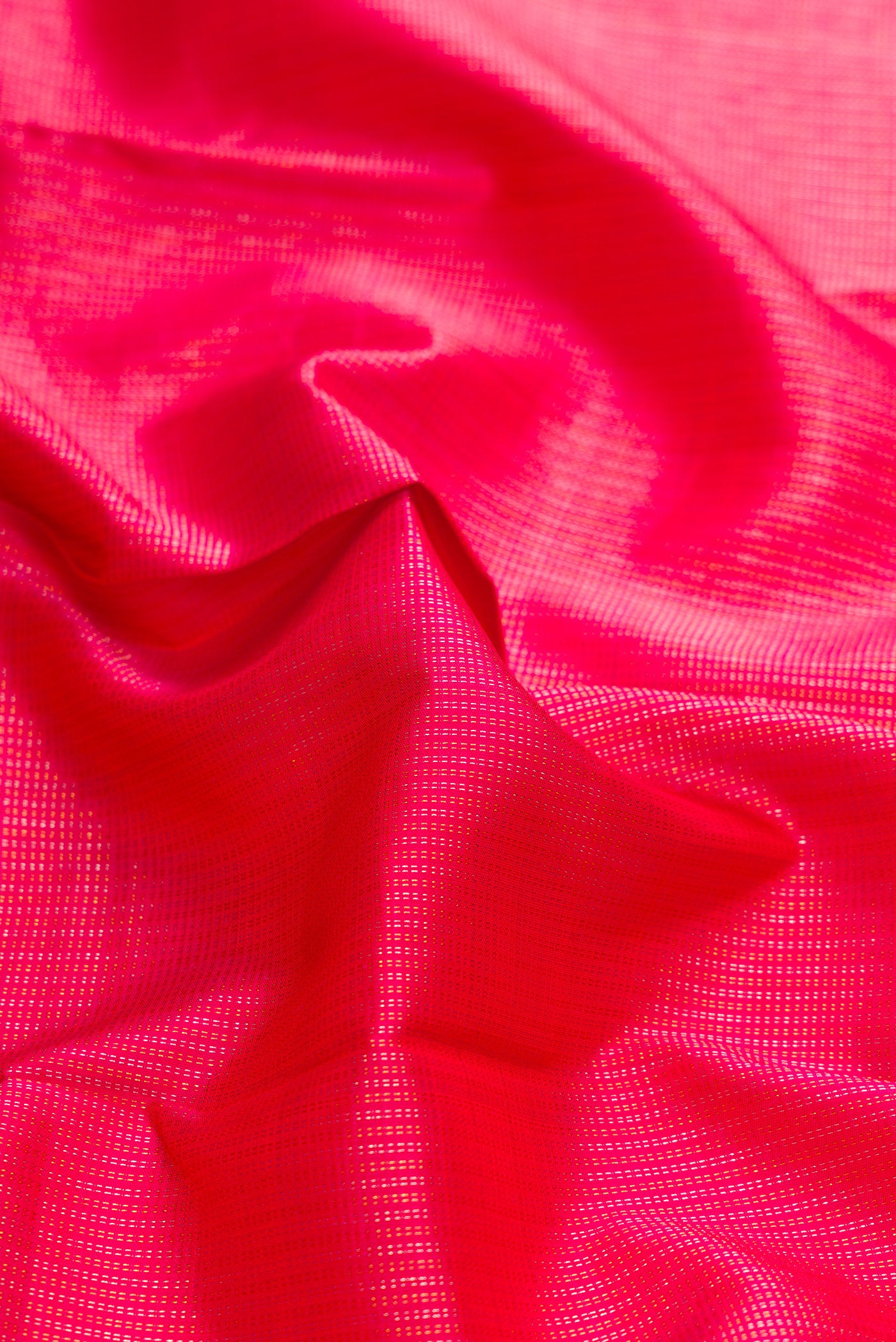 Close up of Pink Dual Tone Kanchipuram Silk Saree with Stripes on the body and Zari Border.  displaying folds