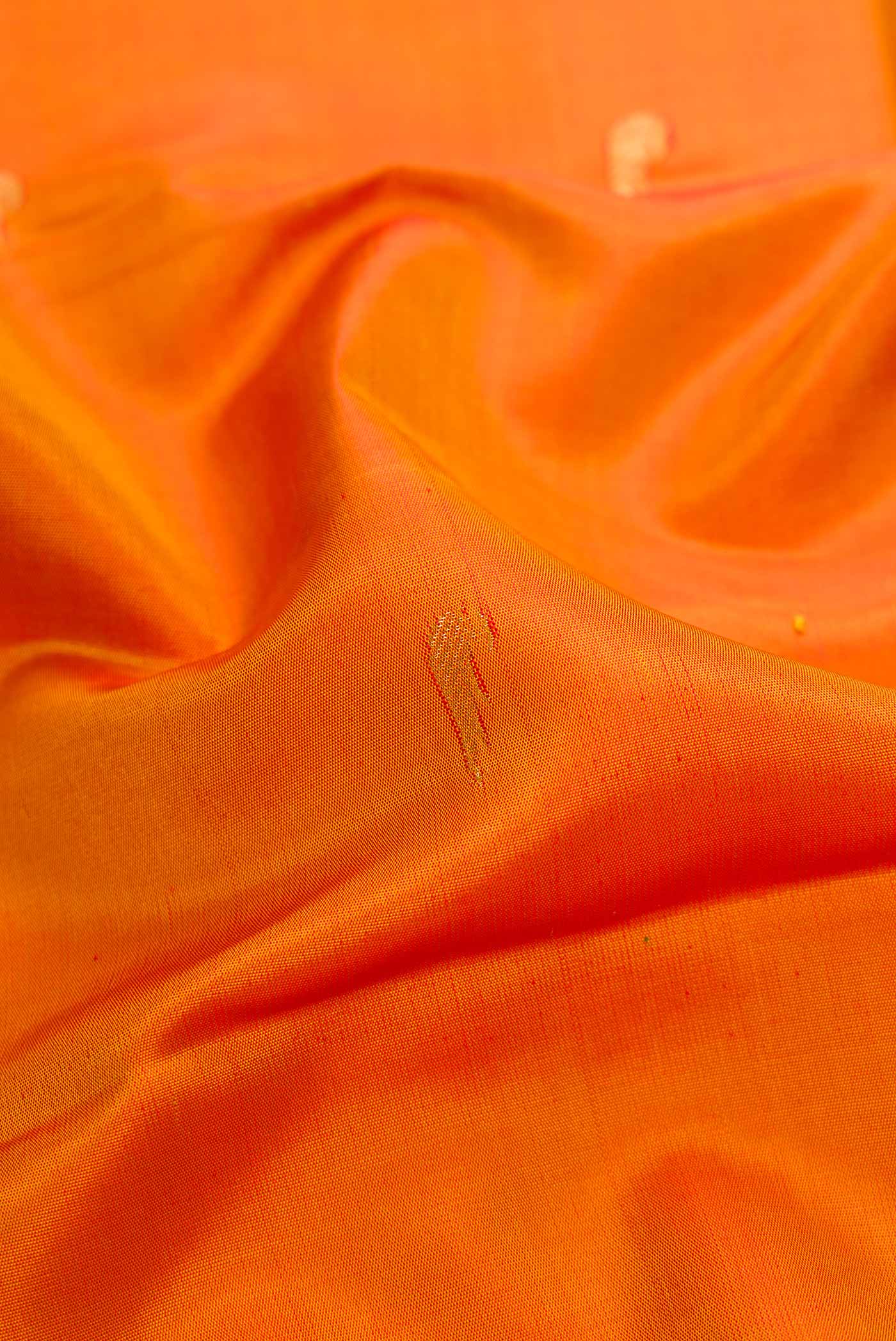 Close up of Mustard Dual Tone Kanjivaram Silk Saree with Zari Butta on the body and Temple Border.  displaying folds