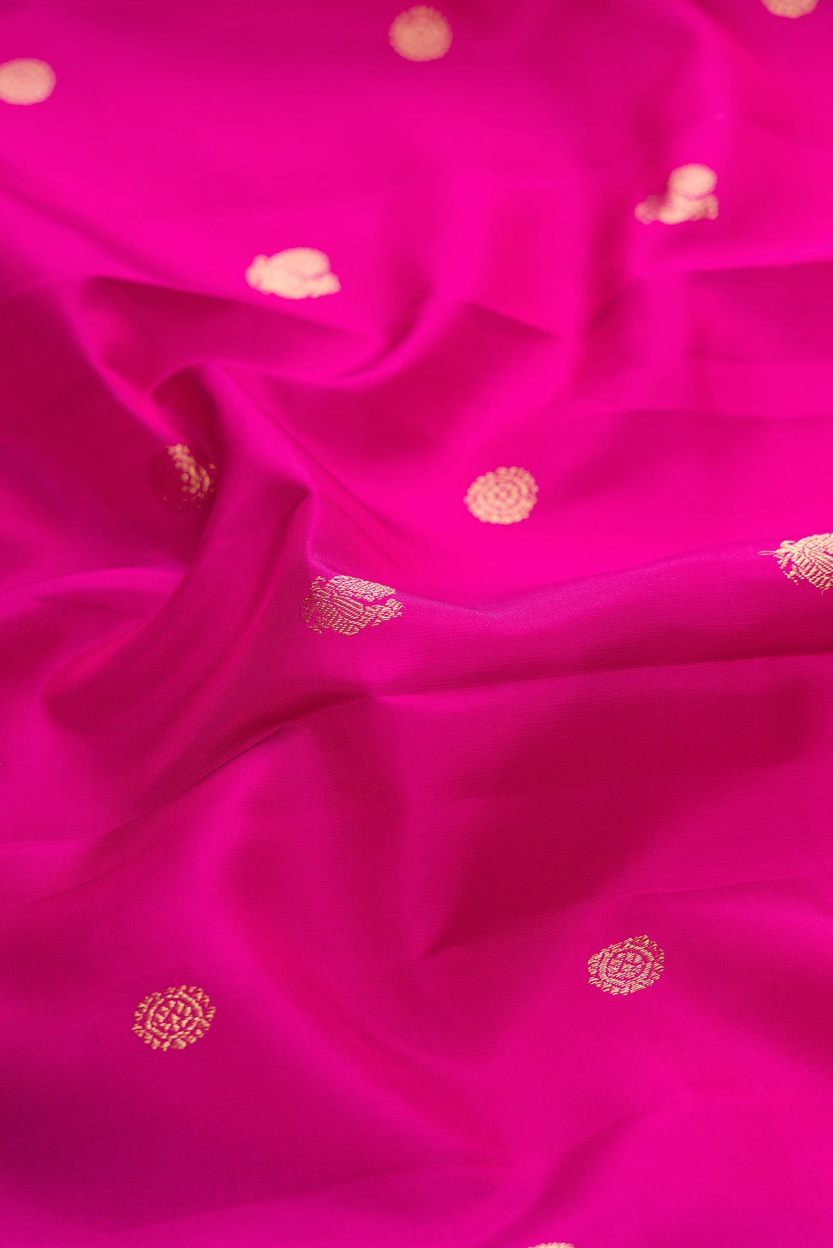 Close up of Pink Dual Tone Kanchipuram Silk Saree with Zari Butta on the body and Zari Border displaying folds