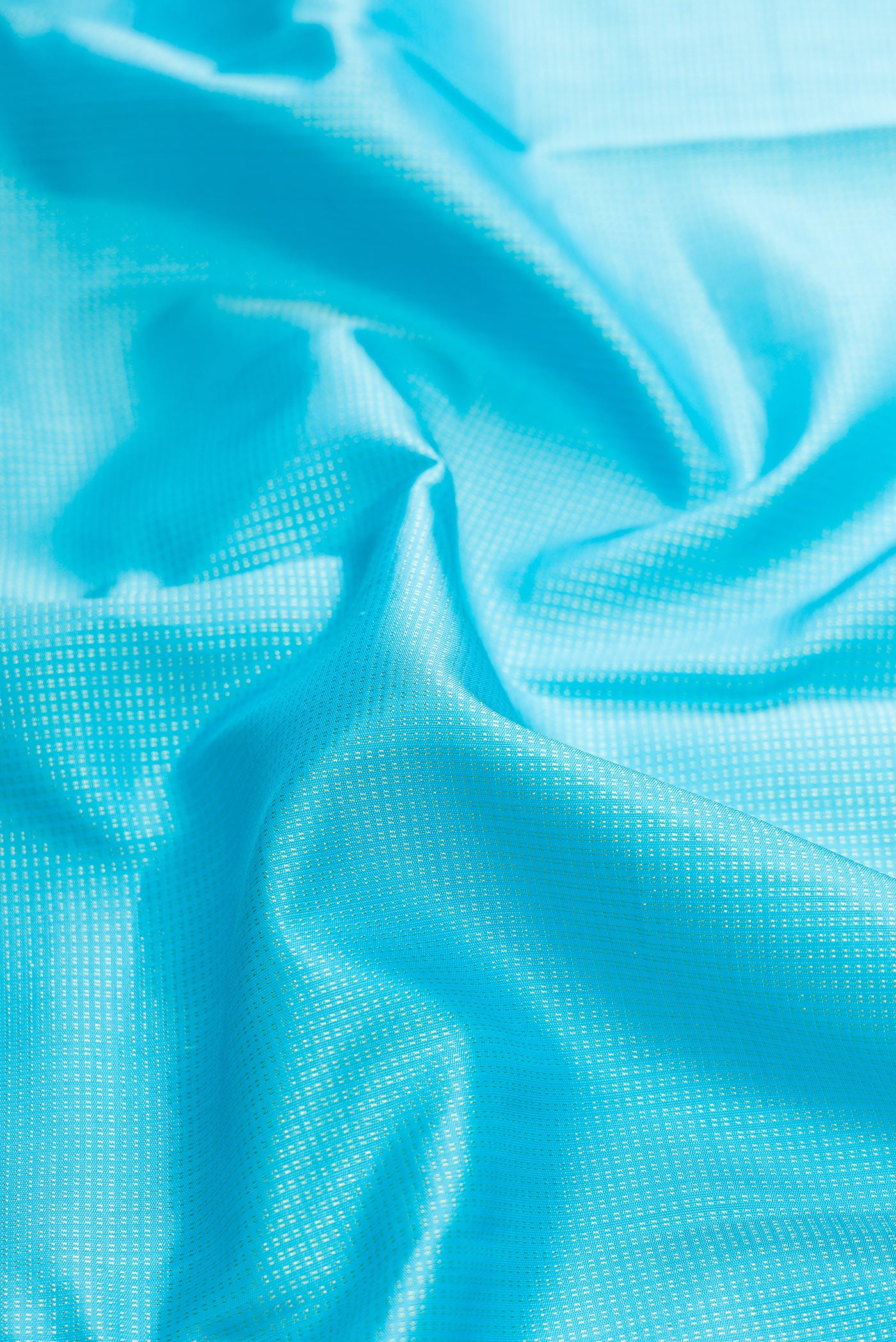 Close up of Sky Blue Dual Tone Kanjivaram Silk Saree with Stripes on the body and Zari Border.  displaying folds