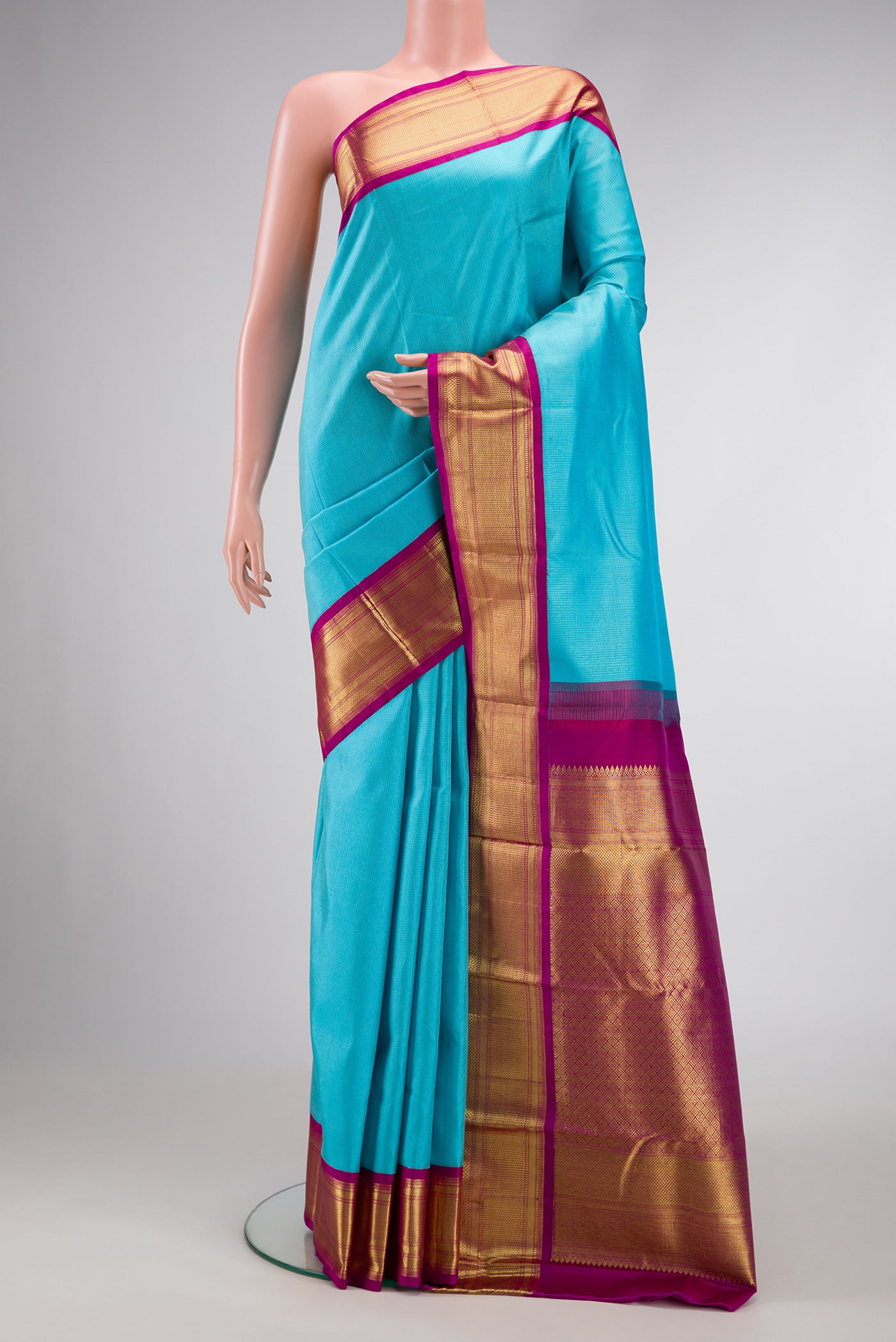 Sky Blue Dual Tone Kanjivaram Silk Saree with Stripes on the body and Zari Border.  displayed on a mannequin