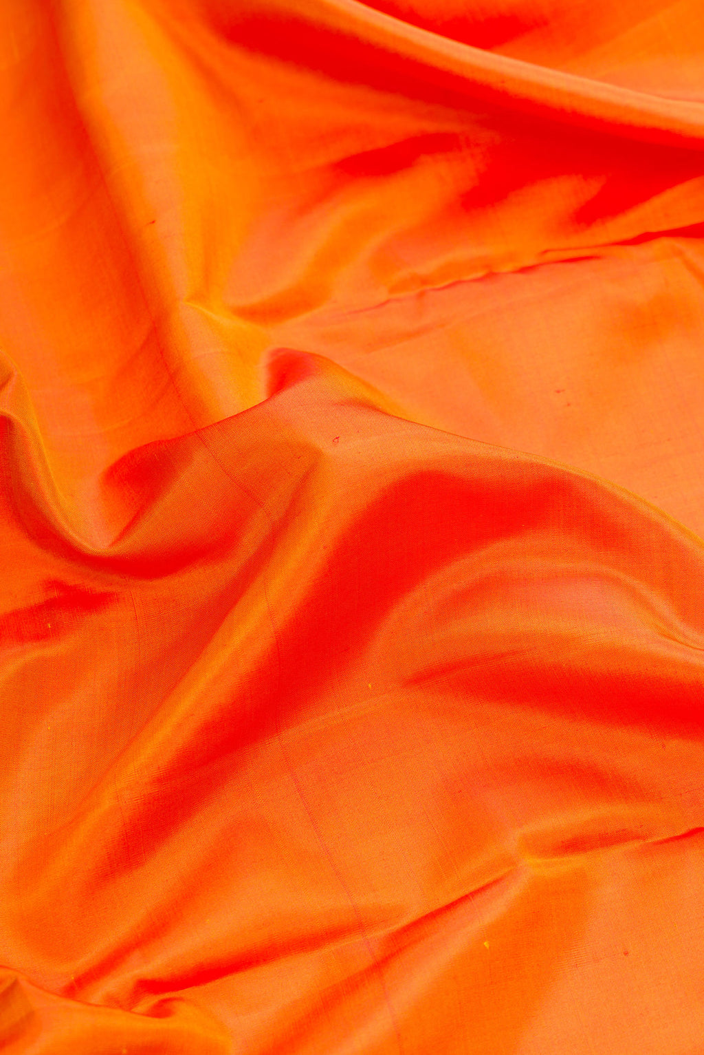 Close up of Orange Dual Tone Kanjivaram Silk Nine Yards Saree with Plain Body and Zari Border.  displaying folds