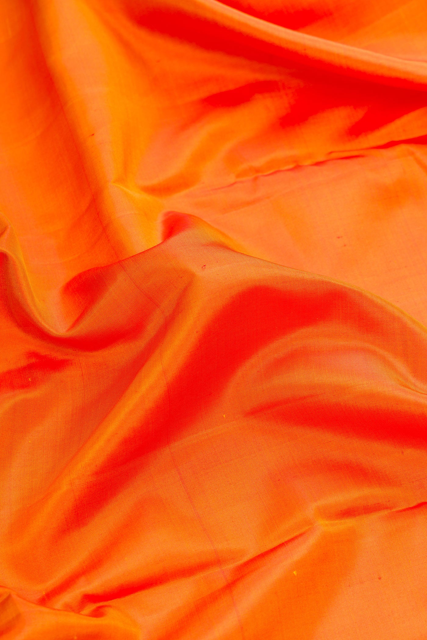 Close up of Orange Dual Tone Kanjivaram Silk Nine Yards Saree with Plain Body and Zari Border.  displaying folds