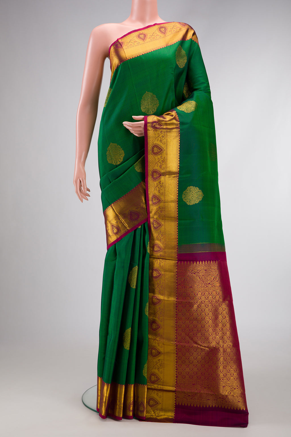 Green Dual Tone Kanjivaram Silk Saree with Zari Butta on the body and Zari Border.  displayed on a mannequin