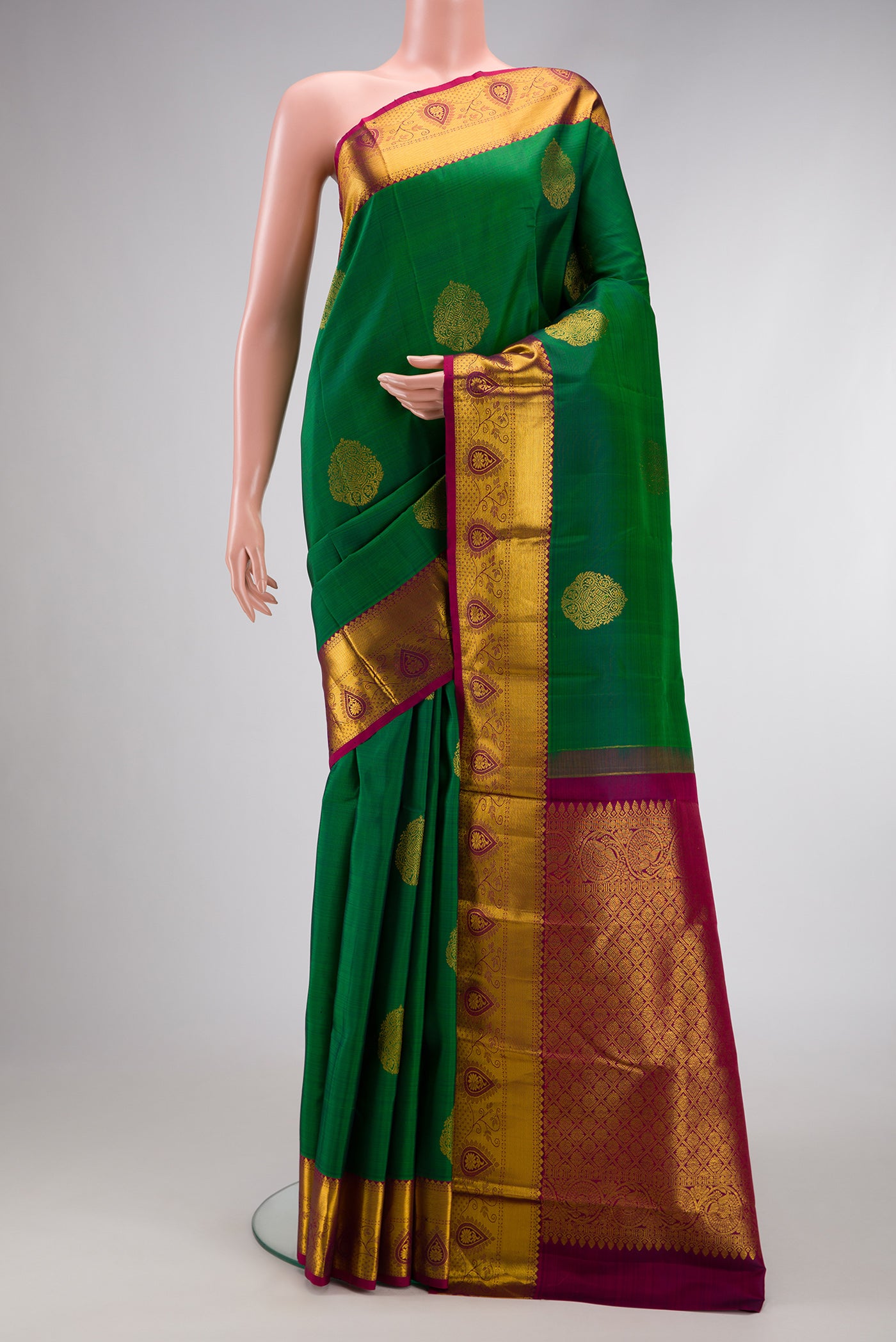 Green Dual Tone Kanjivaram Silk Saree with Zari Butta on the body and Zari Border.  displayed on a mannequin