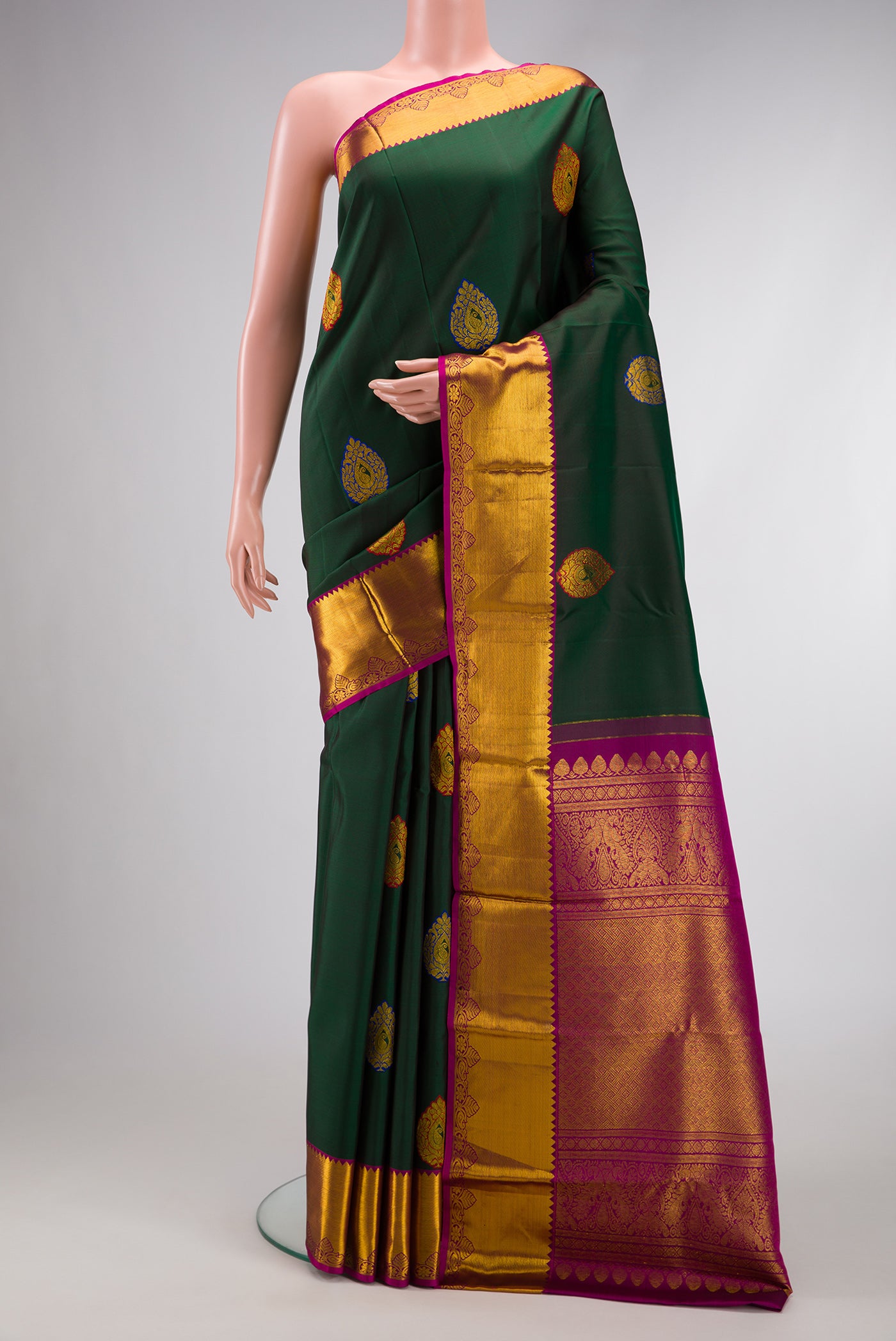 Green Dual Tone Kanchipuram Silk Saree with Zari And Thread Butta on the body and Zari Border.  displayed on a mannequin