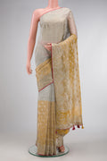 Gold Dual Tone Organza Silk Saree with Zari Butta on the body and Embroidery Border.  displayed on a mannequin