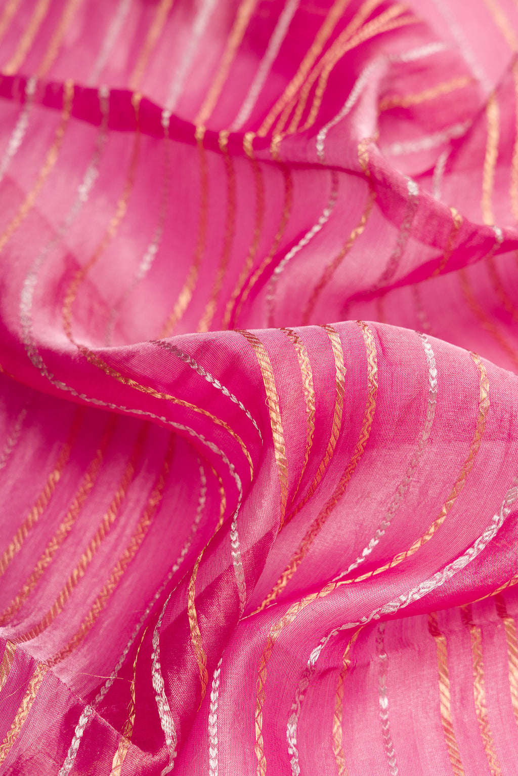 Close up of Pink Dual Tone Organza Silk Saree with Stripes on the body and Zari Border.  displaying folds
