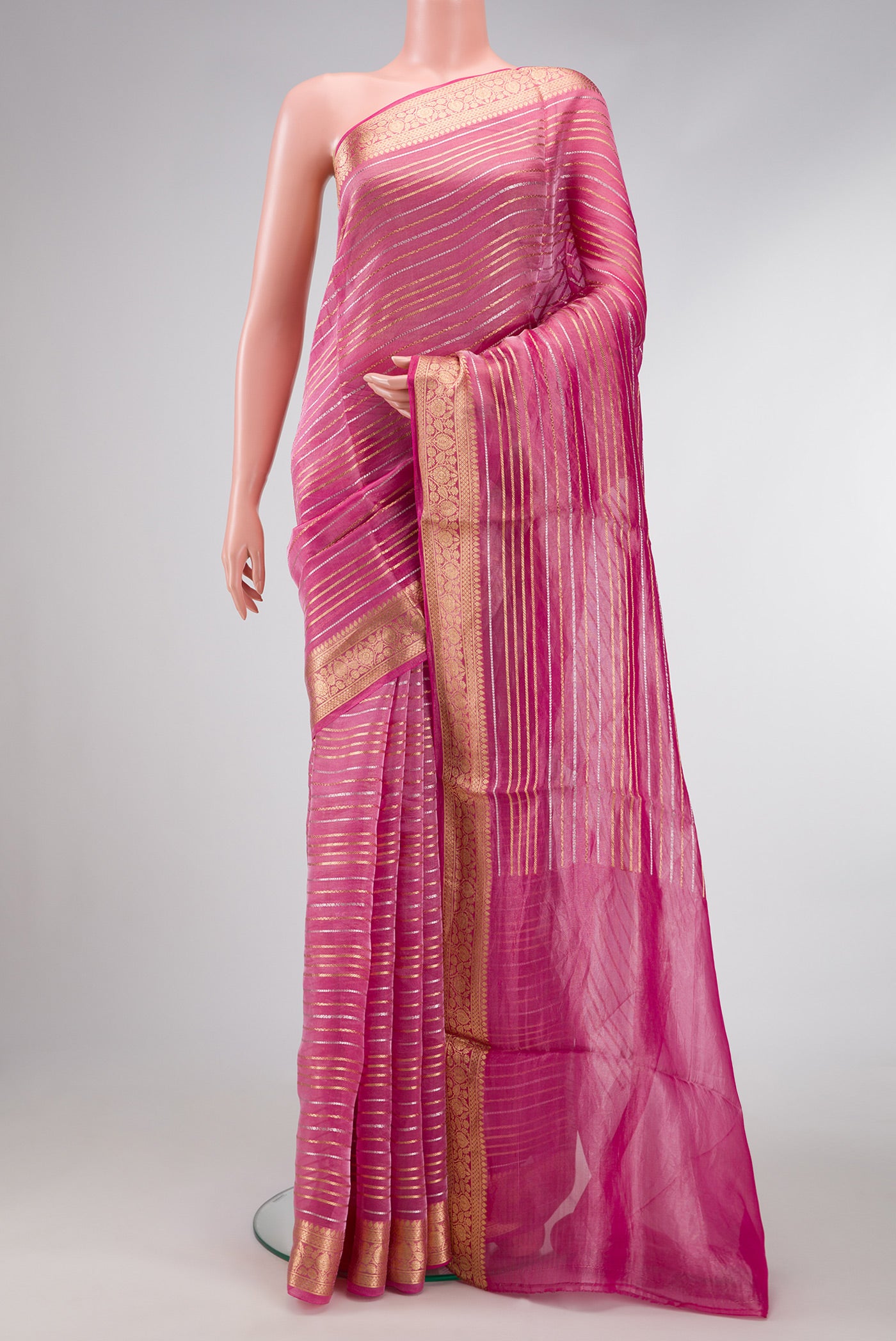 Pink Dual Tone Organza Silk Saree with Stripes on the body and Zari Border.  displayed on a mannequin