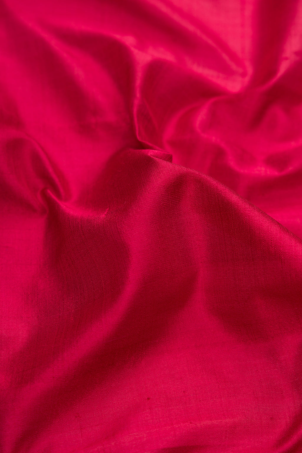 Close up of Maroon Kanchipuram Silk Saree with Plain Body and Fancy Border.  displaying folds
