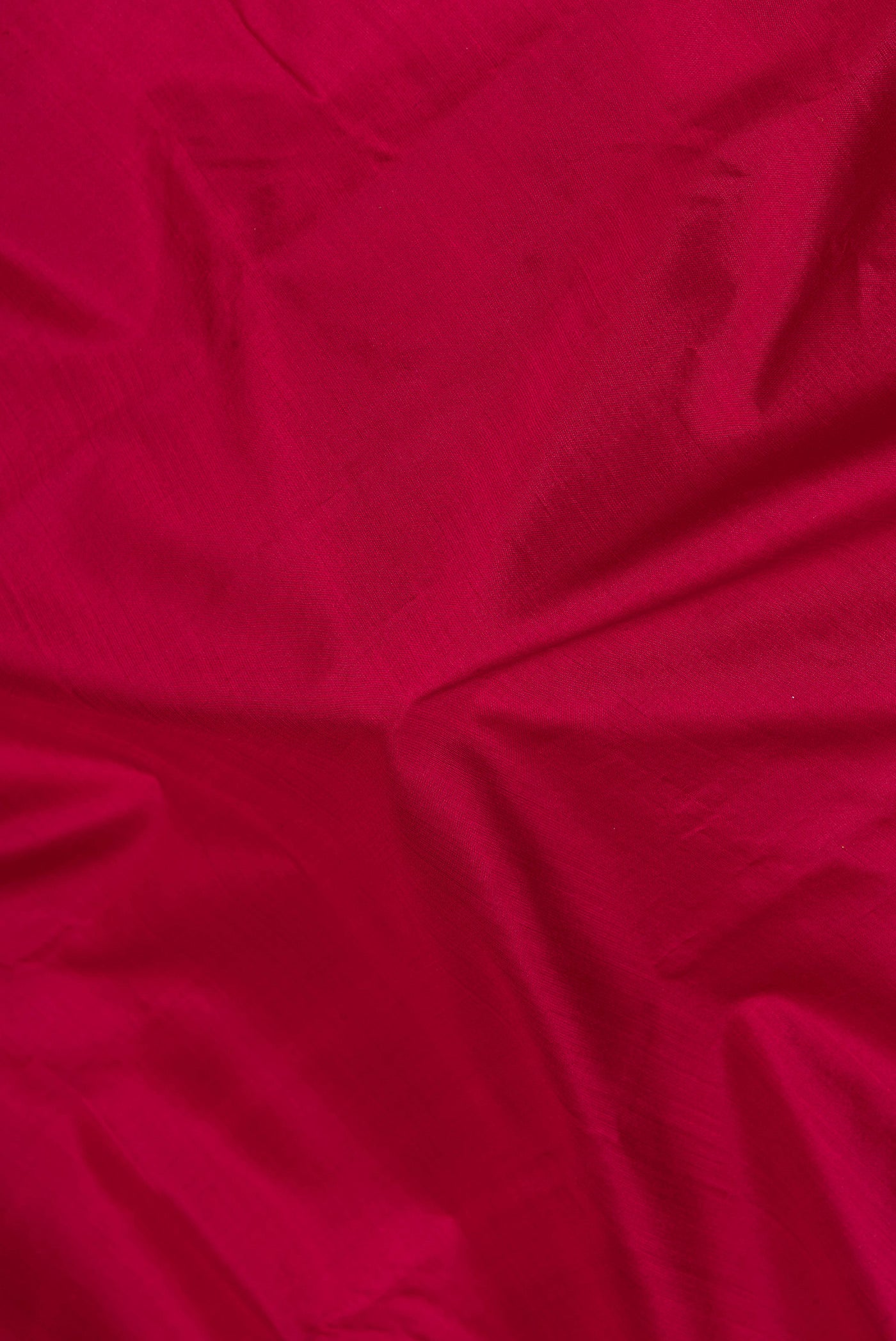 Close up of Maroon Kanjivaram Silk Saree with Plain Body and Zari Border.  displaying folds