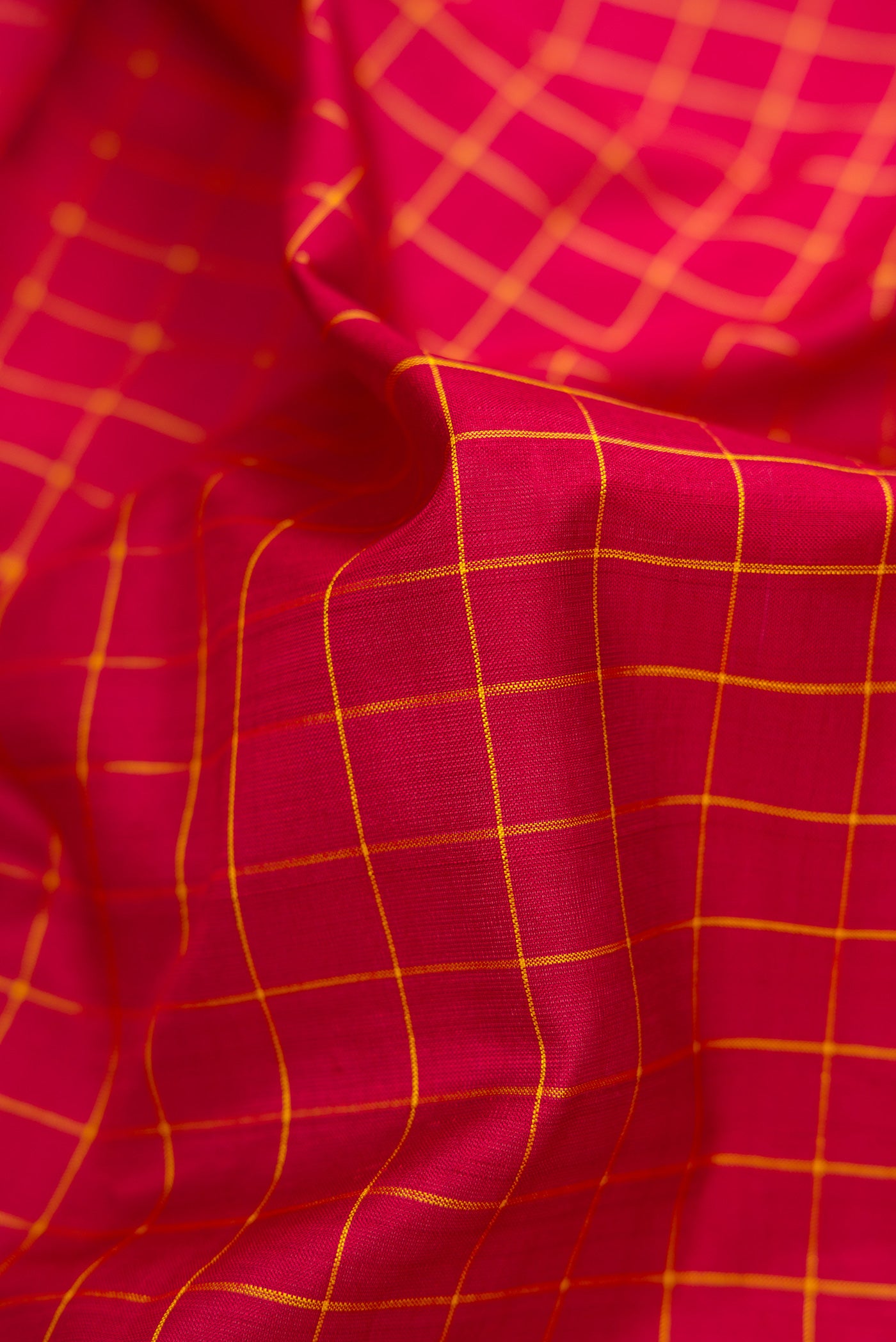 Close up of Pure Silk Pure Zari Maroon Dual Tone Kanchipuram Nine Yards Saree with Checked design on the body and Zari Border.  displaying folds