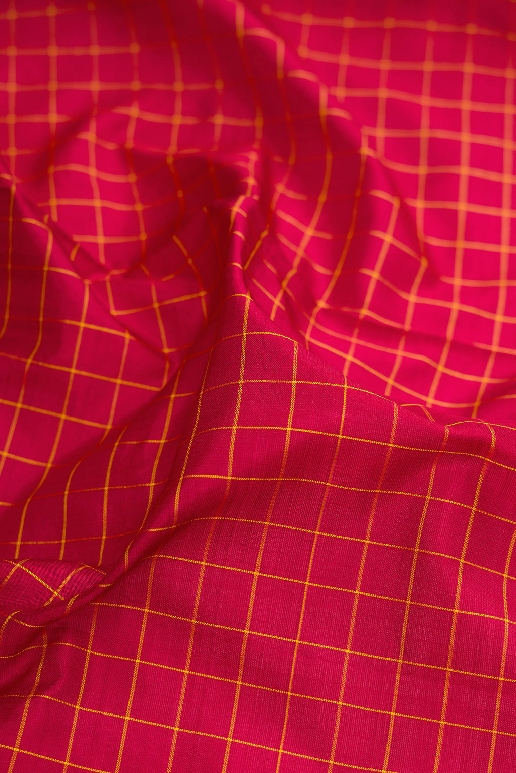 Close up of Maroon Kanchipuram Silk Nine Yards Saree with Checked design on the body and Zari Border.  displaying folds