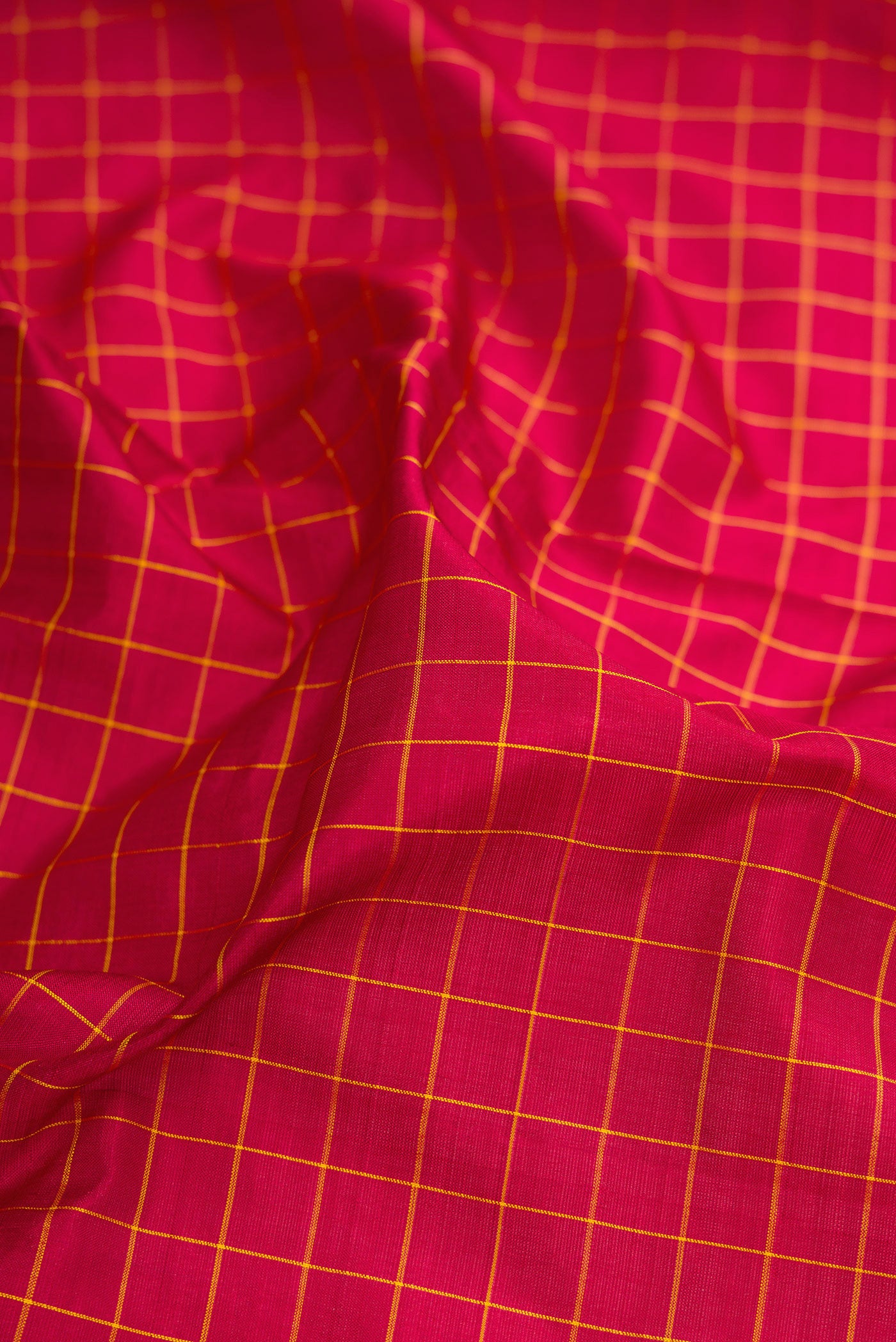 Close up of Maroon Kanchipuram Silk Nine Yards Saree with Checked design on the body and Zari Border.  displaying folds