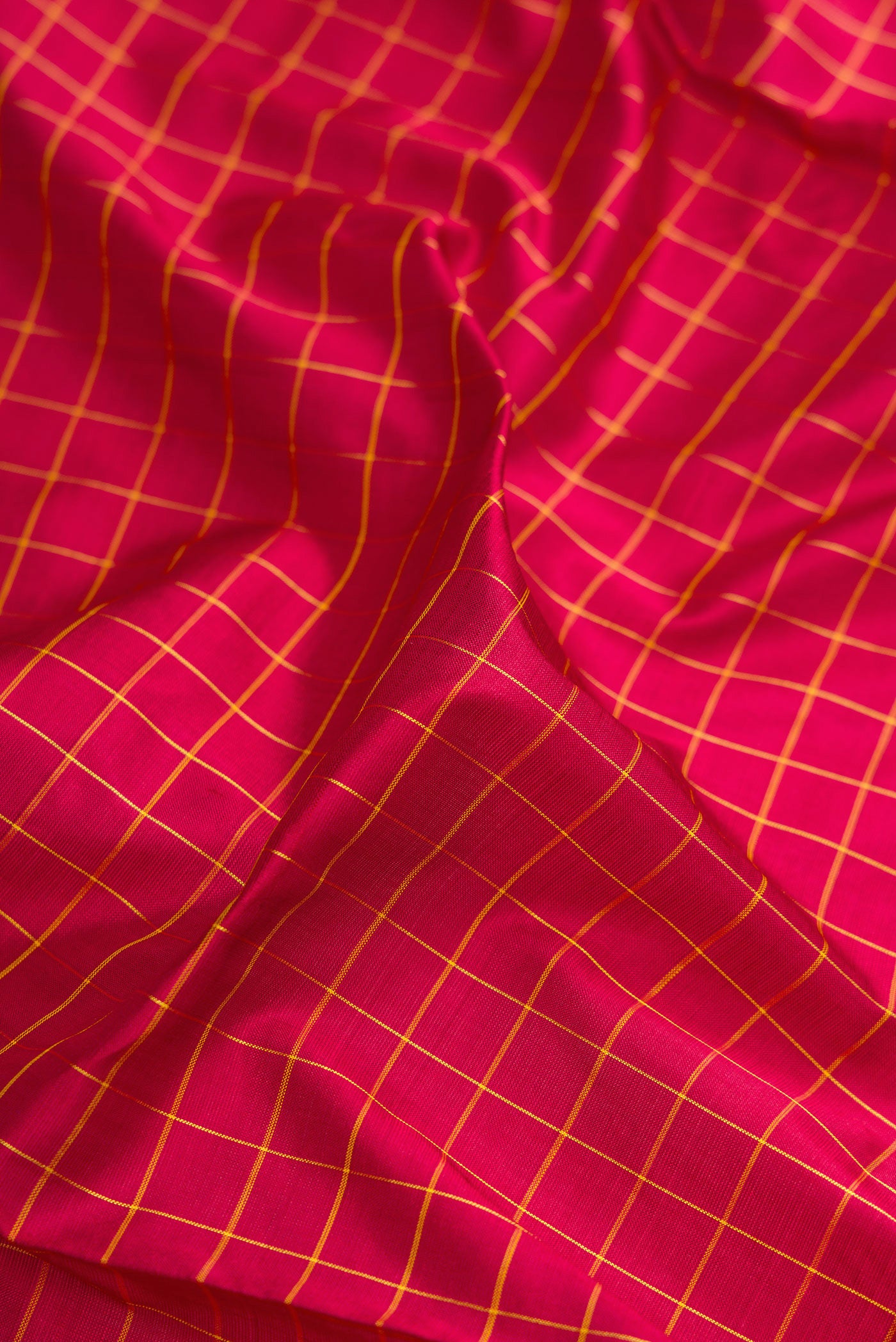 Close up of Maroon Kanjivaram Silk Nine Yards Saree with Checked design on the body and Zari Border.  displaying folds