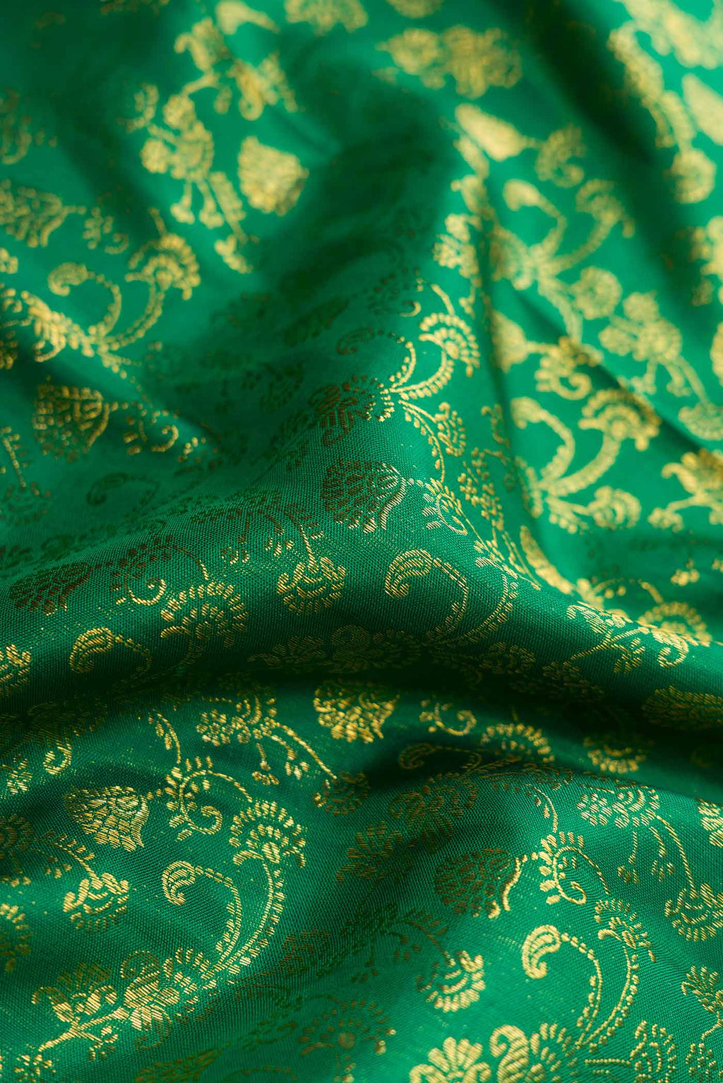 Close up of Green Dual Tone Kanchipuram Silk Saree with Zari Brocade on the body and Zari Border displaying folds