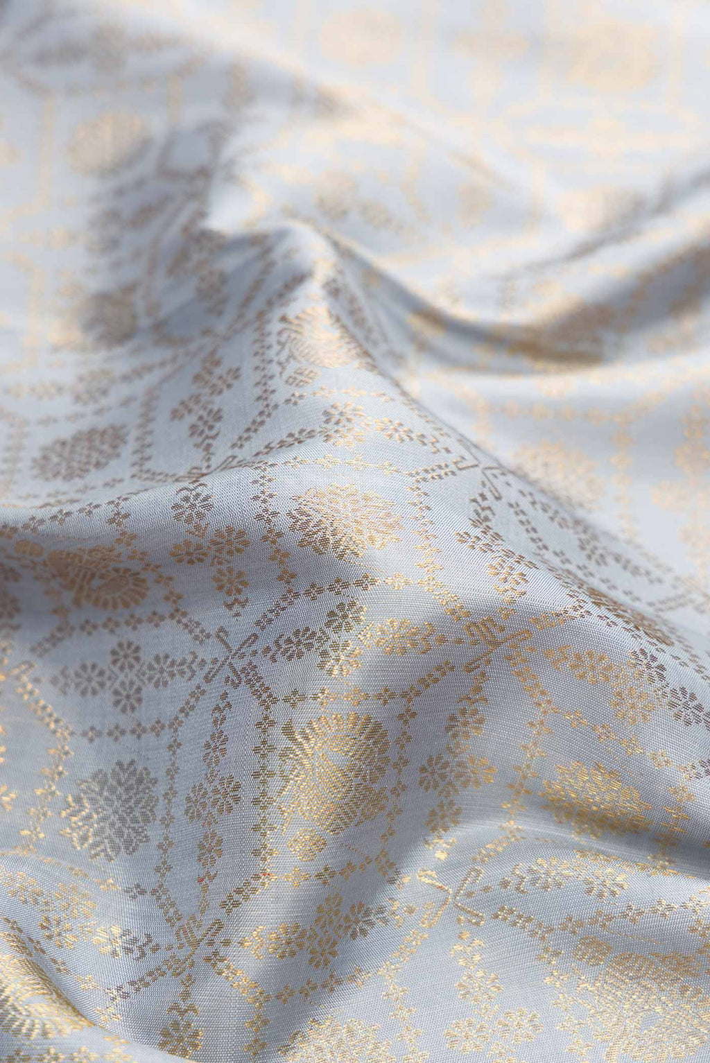 Close up of Grey Dual Tone Kanchipuram Silk Saree with Zari Brocade on the body and Zari Border.  displaying folds