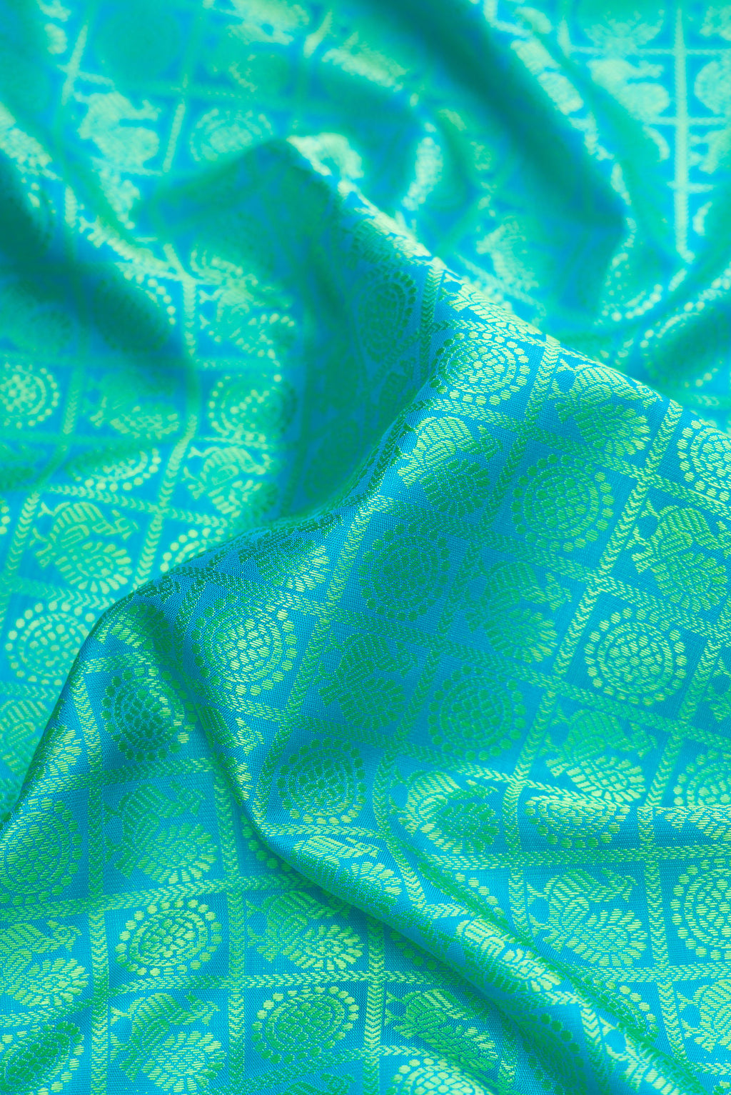Close up of Pure Silk Pure Zari Sea Green Dual Tone Kanjivaram Saree with Jacquard design on the body and Fancy Border.  displaying folds