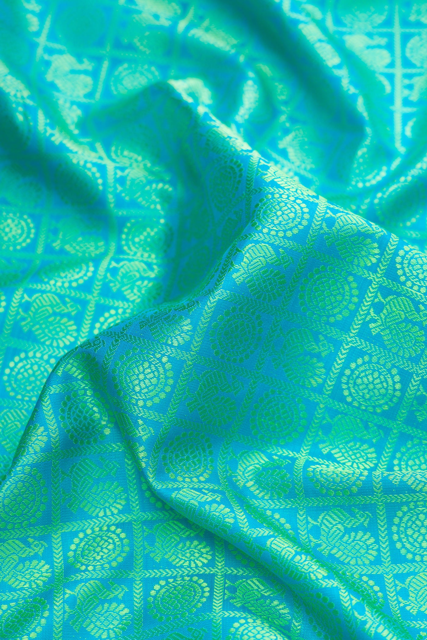 Close up of Pure Silk Pure Zari Sea Green Dual Tone Kanjivaram Saree with Jacquard design on the body and Fancy Border.  displaying folds