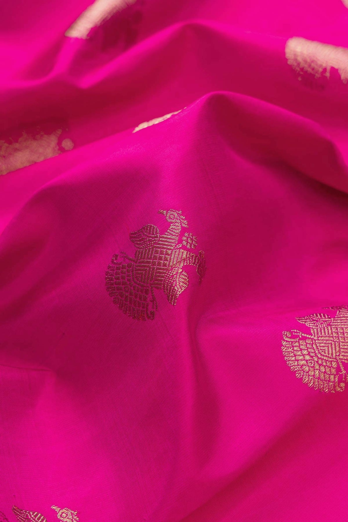 Close up of Pure Silk Pure Zari Pink Dual Tone Kanchipuram Saree with Zari Butta on the body and Zari Border displaying folds