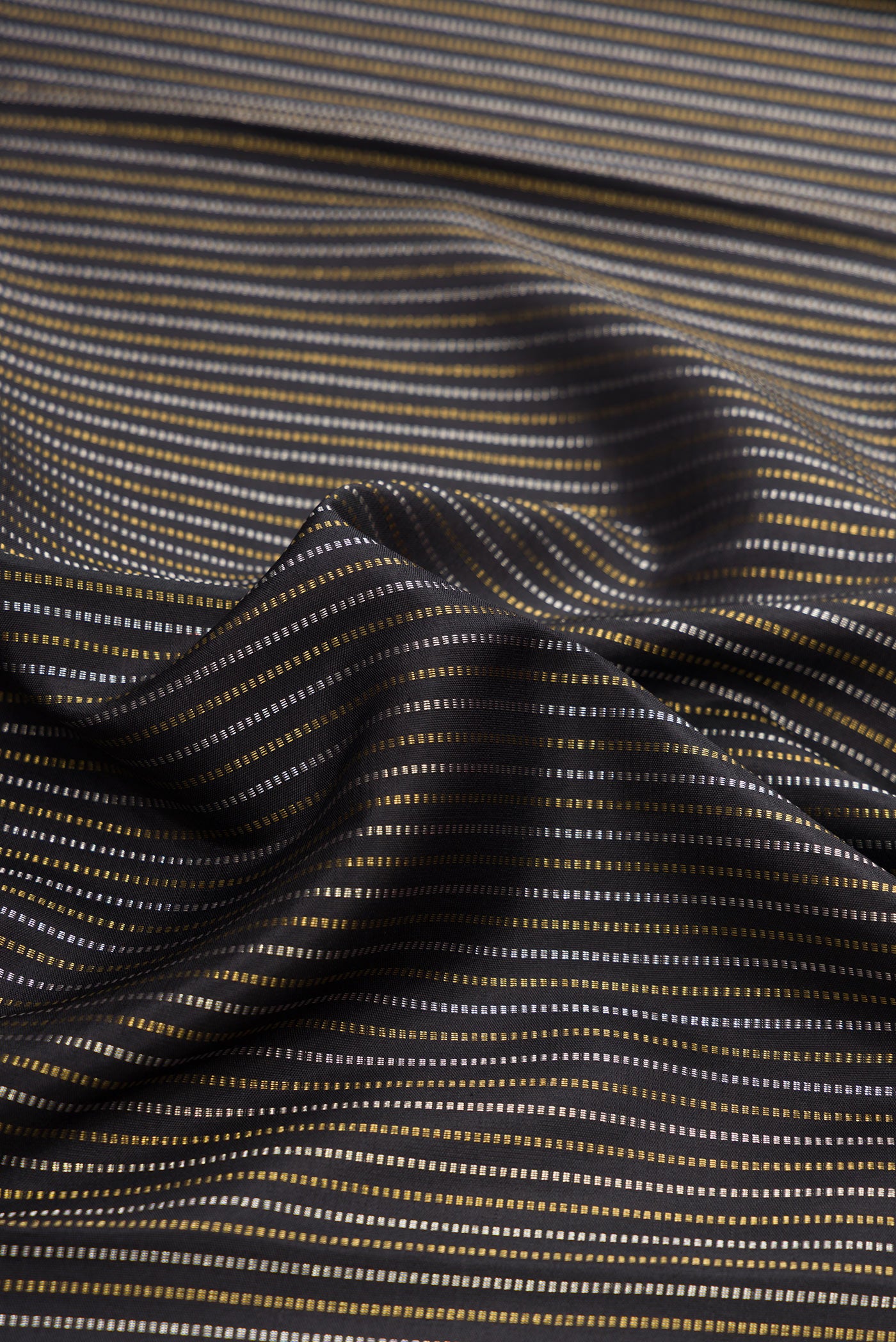 Close up of Pure Silk Pure Zari Black Dual Tone Kanchipuram Saree with Stripes on the body and Zari Border.  displaying folds