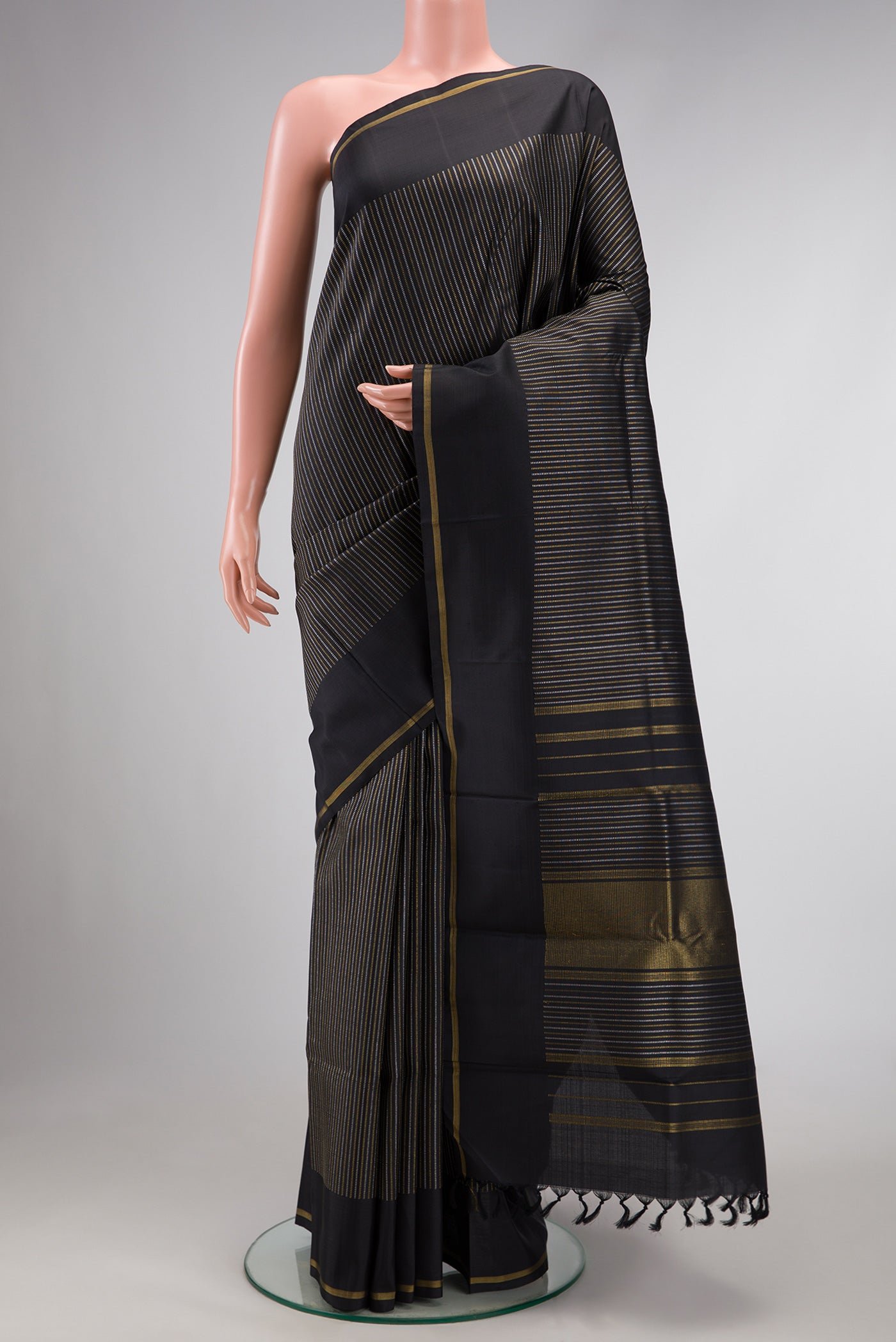 Pure Silk Pure Zari Black Dual Tone Kanchipuram Saree with Stripes on the body and Zari Border.  displayed on a mannequin