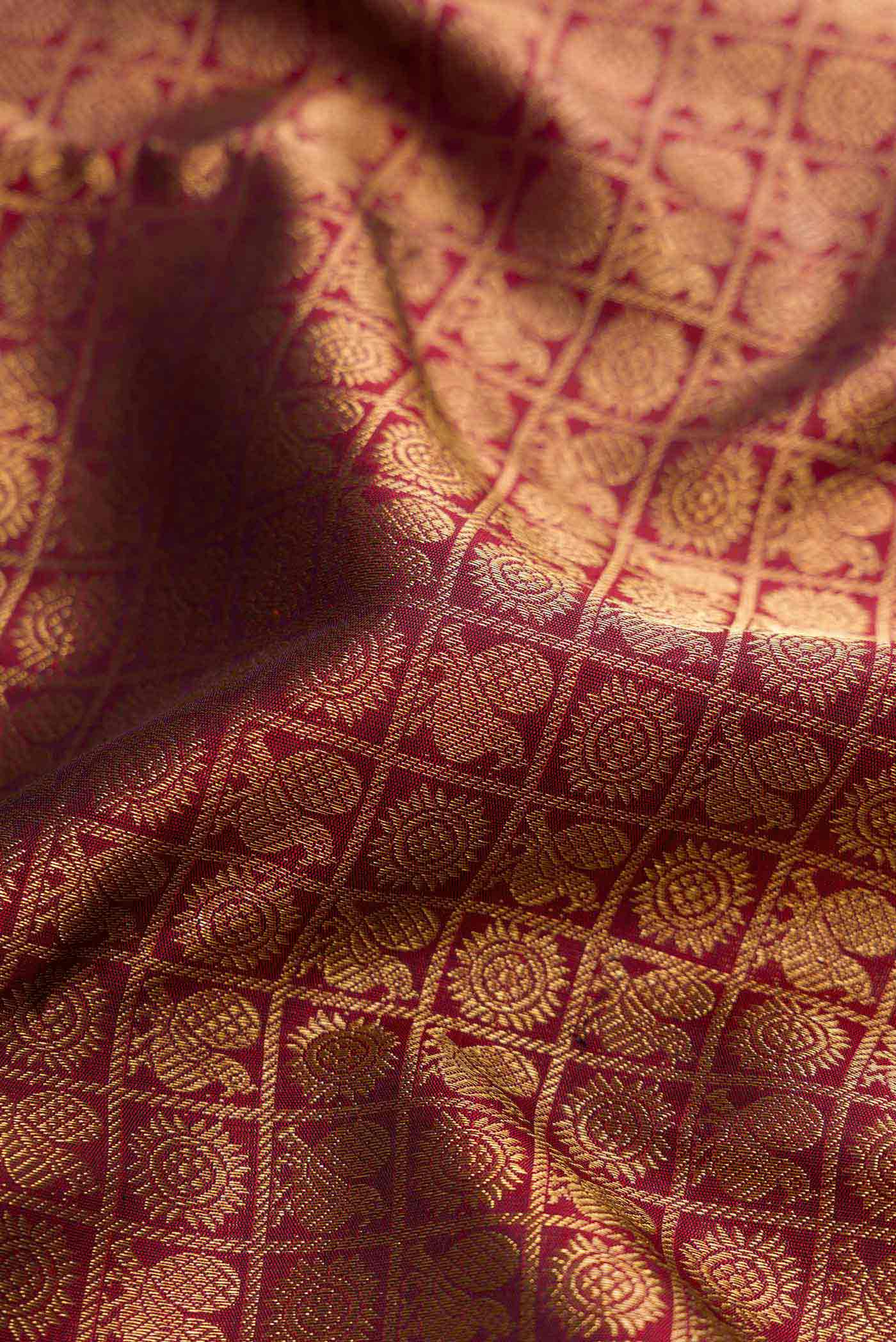 Close up of Maroon Dual Tone Kanchipuram Silk Saree with Zari Brocade on the body and Zari Border displaying folds