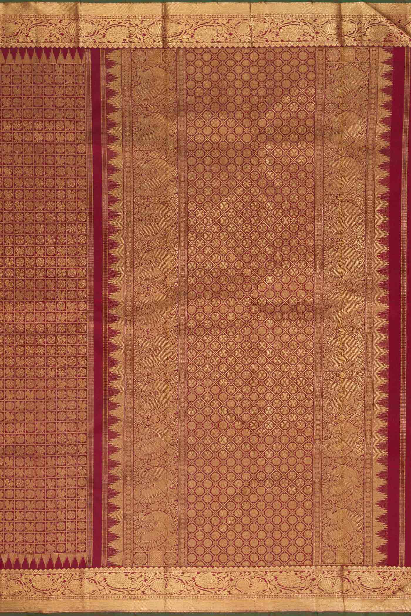 Close up image of the pallu of Maroon Dual Tone Kanchipuram Silk Saree with Zari Brocade on the body and Zari Border