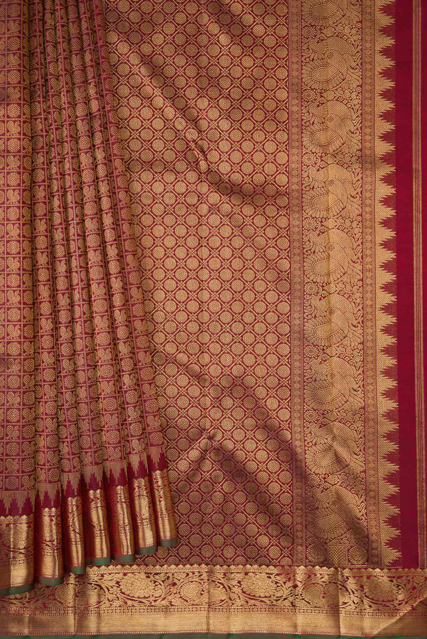 Pleats and pallu of Maroon Dual Tone Kanchipuram Silk Saree with Zari Brocade on the body and Zari Border