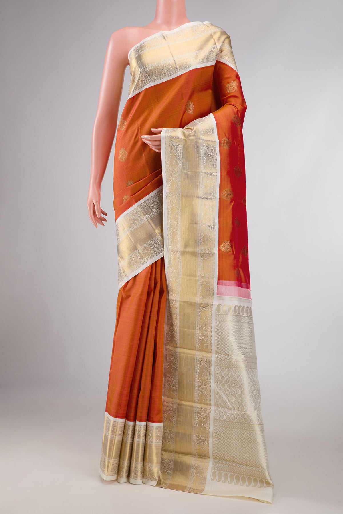 Pure Silk Pure Zari Orange Dual Tone Kanchipuram Saree with Zari Butta on the body and Zari Border displayed on a mannequin