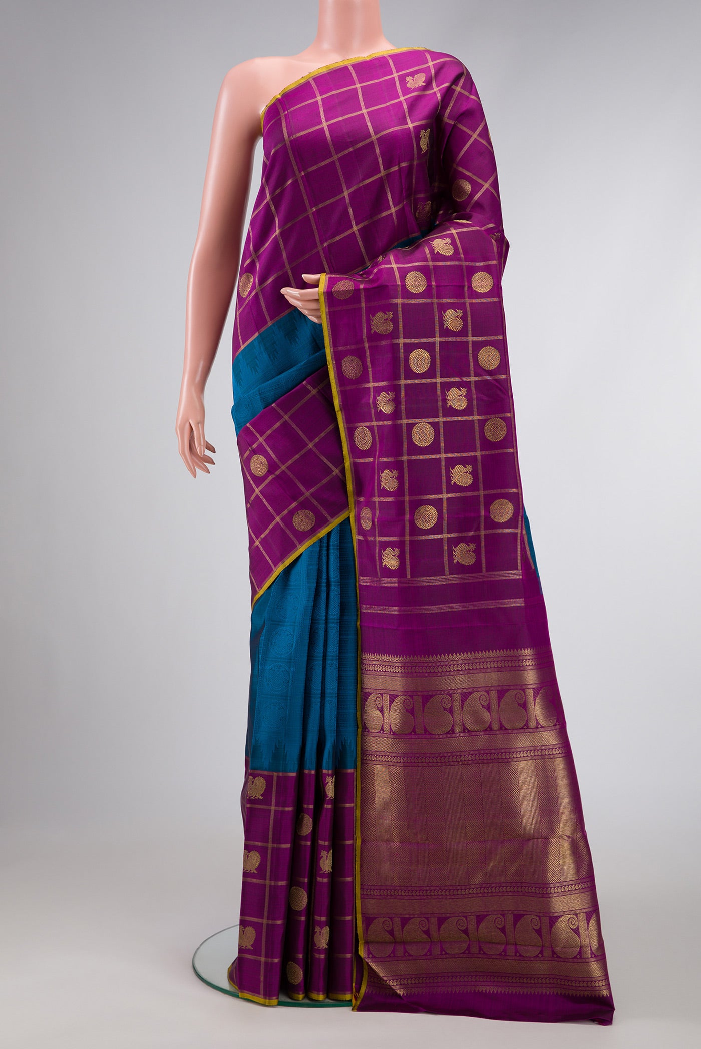Pure Silk Pure Zari Peacock Blue Dual Tone Kanchipuram Saree with Jacquard design on the body and Checks Border.  displayed on a mannequin