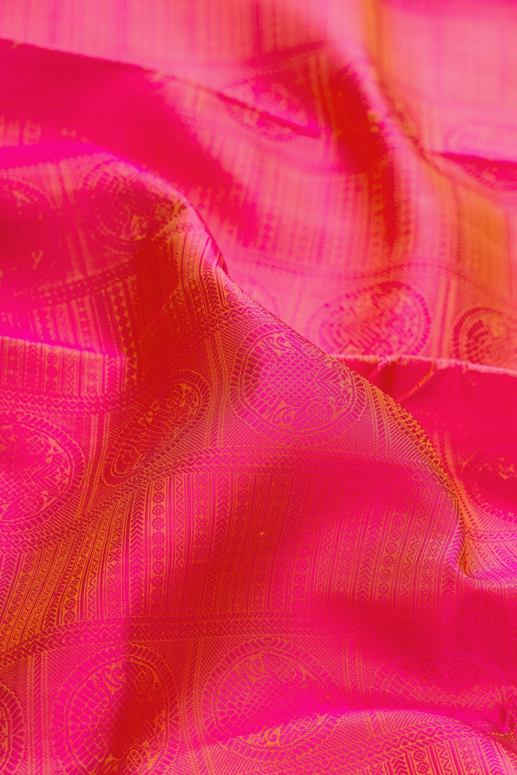 Close up of Pure Silk Pure Zari Coral Dual Tone Kanchipuram Saree with Jacquard design on the body and Checks Border.  displaying folds