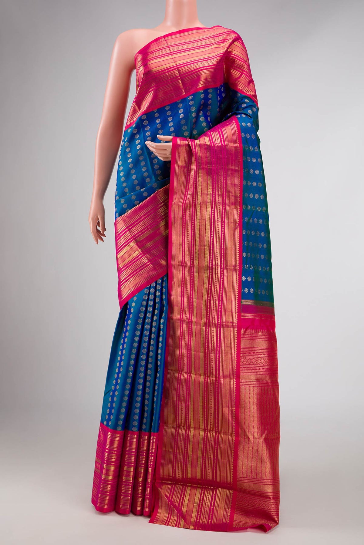 Pure Silk Pure Zari Peacock Blue Dual Tone Kanchipuram Saree with Zari Butta on the body and Zari Border displayed on a mannequin