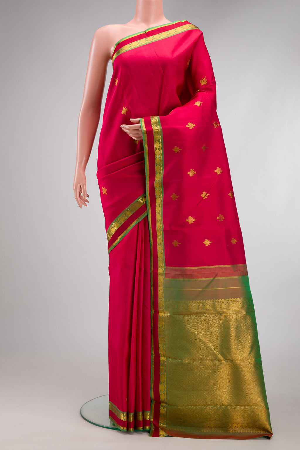 Deep Red Kanchipuram Silk Saree with Zari Butta on the body and Zari Border.  displayed on a mannequin