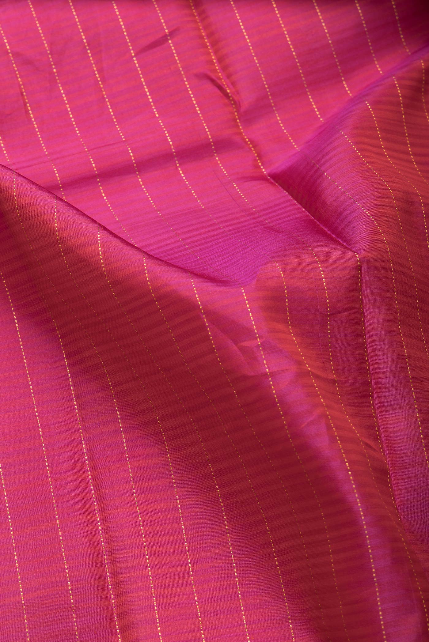 Close up of Pink Dual Tone Kanjivaram Silk Saree with Stripes on the body and Without Border.  displaying folds