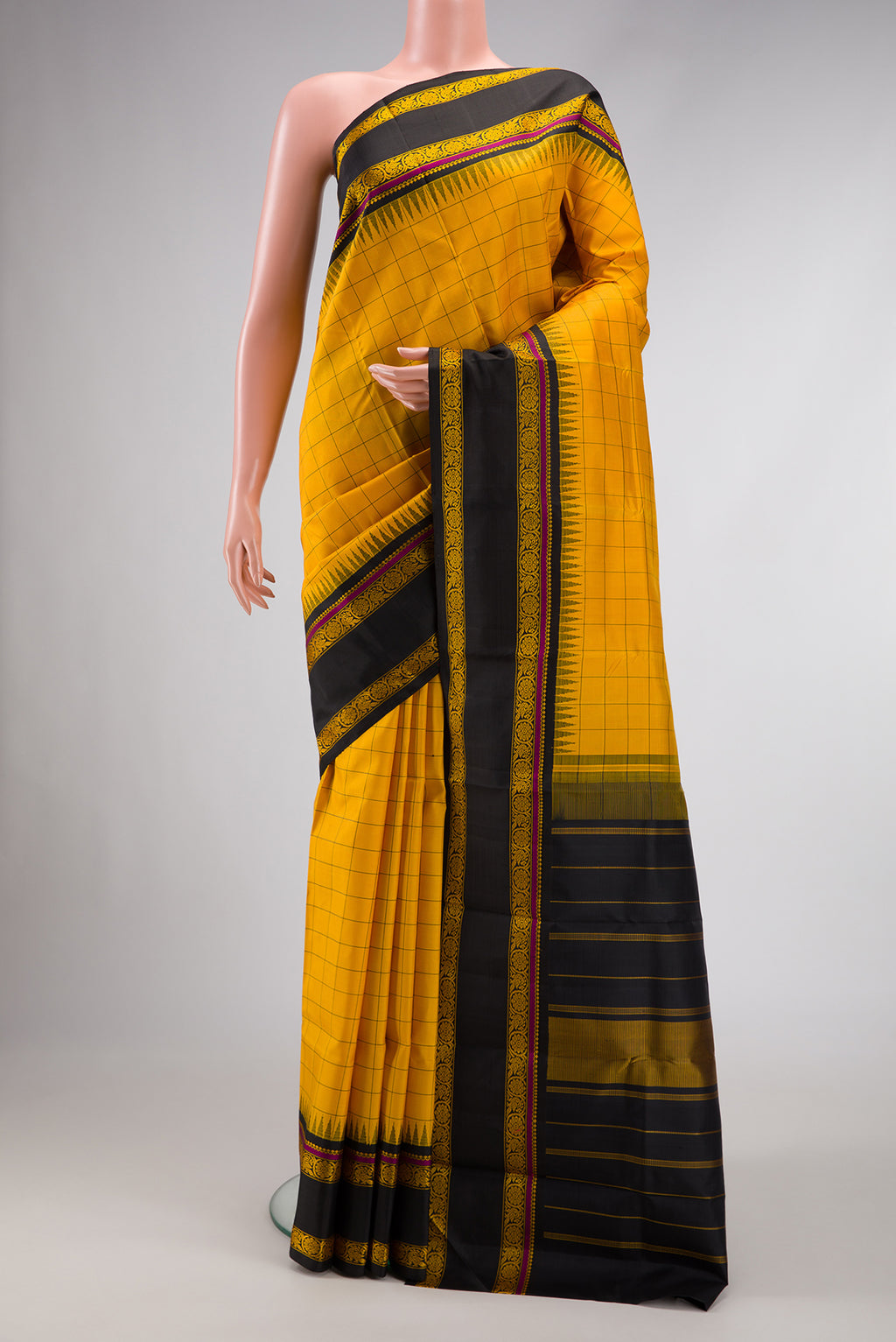 Mustard Dual Tone Kanchipuram Silk Saree with Checked design on the body and Thread Border.  displayed on a mannequin