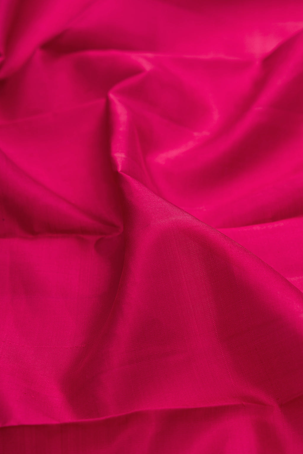 Close up of Maroon Kanjivaram Silk Saree with Plain Body and Zari Border.  displaying folds