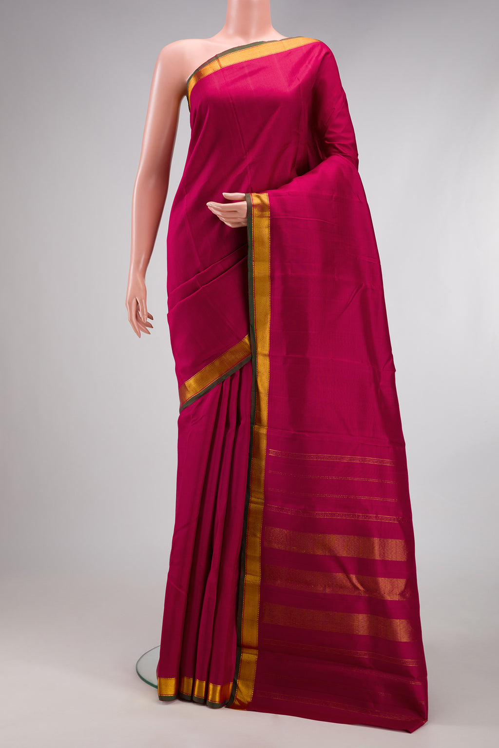 Maroon Kanjivaram Silk Saree with Plain Body and Zari Border.  displayed on a mannequin
