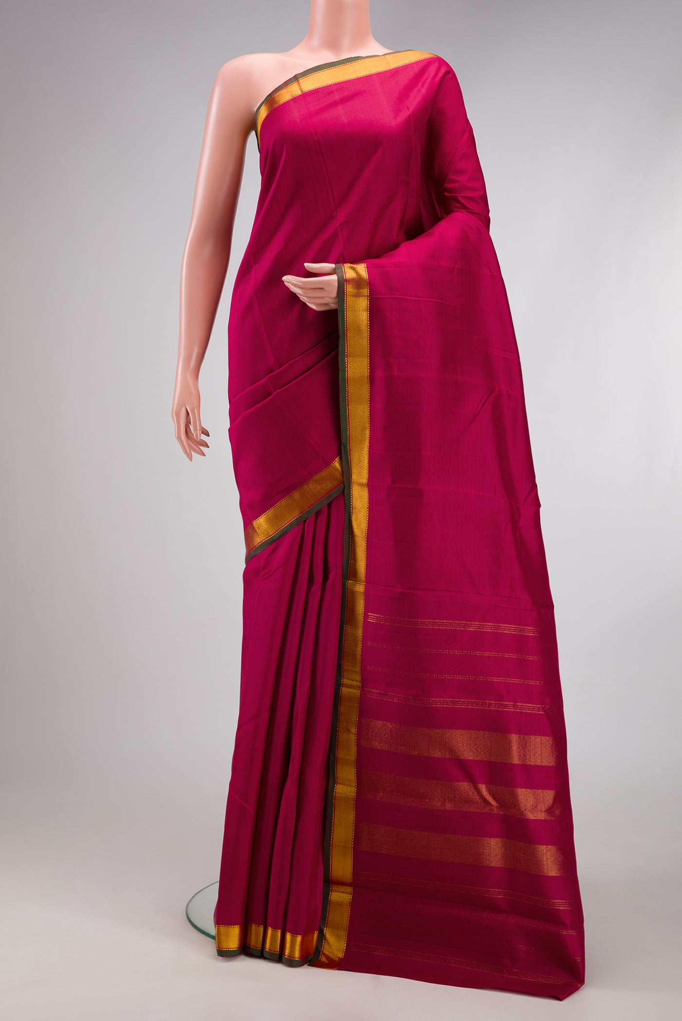 Maroon Kanjivaram Silk Saree with Plain Body and Zari Border.  displayed on a mannequin