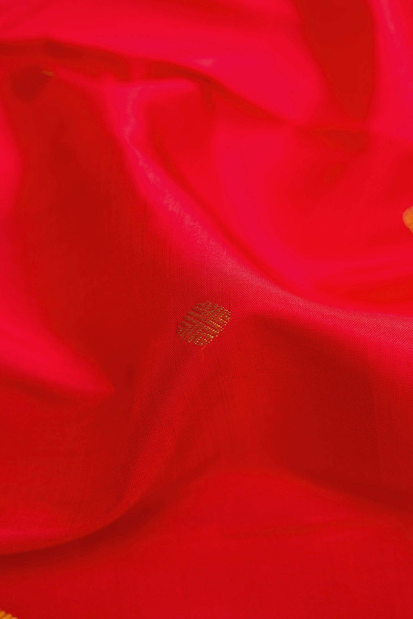 Close up of Red Dual Tone Kanchipuram Silk Saree with Zari Butta on the body and Zari Border displaying folds